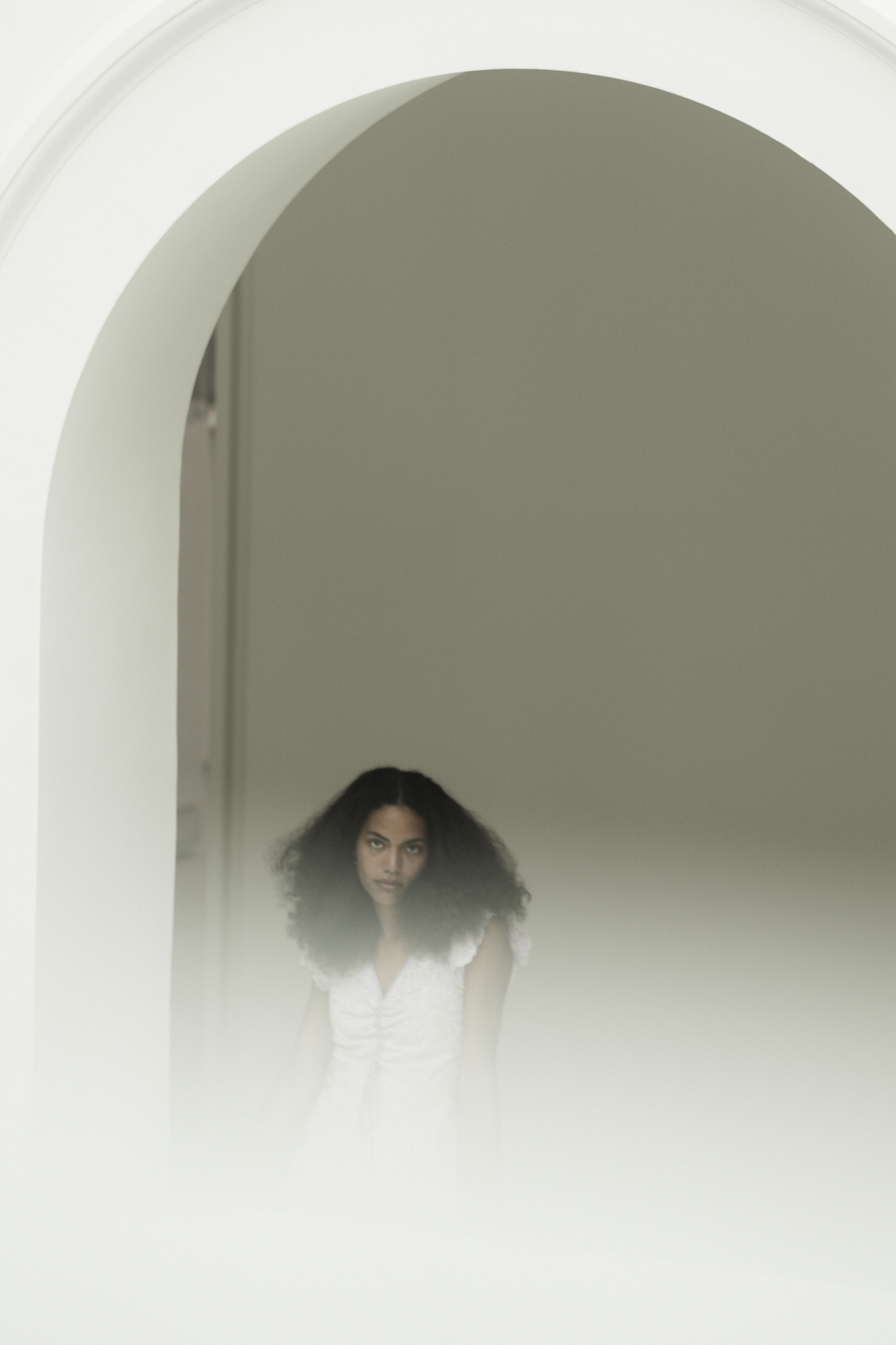 A Dance of Contradictions by FADETOBLACK, fine art portrait photography, image 12: Portraits of a woman with voluminous curly hair in a short ruffled lilac lace dress, moving between bright