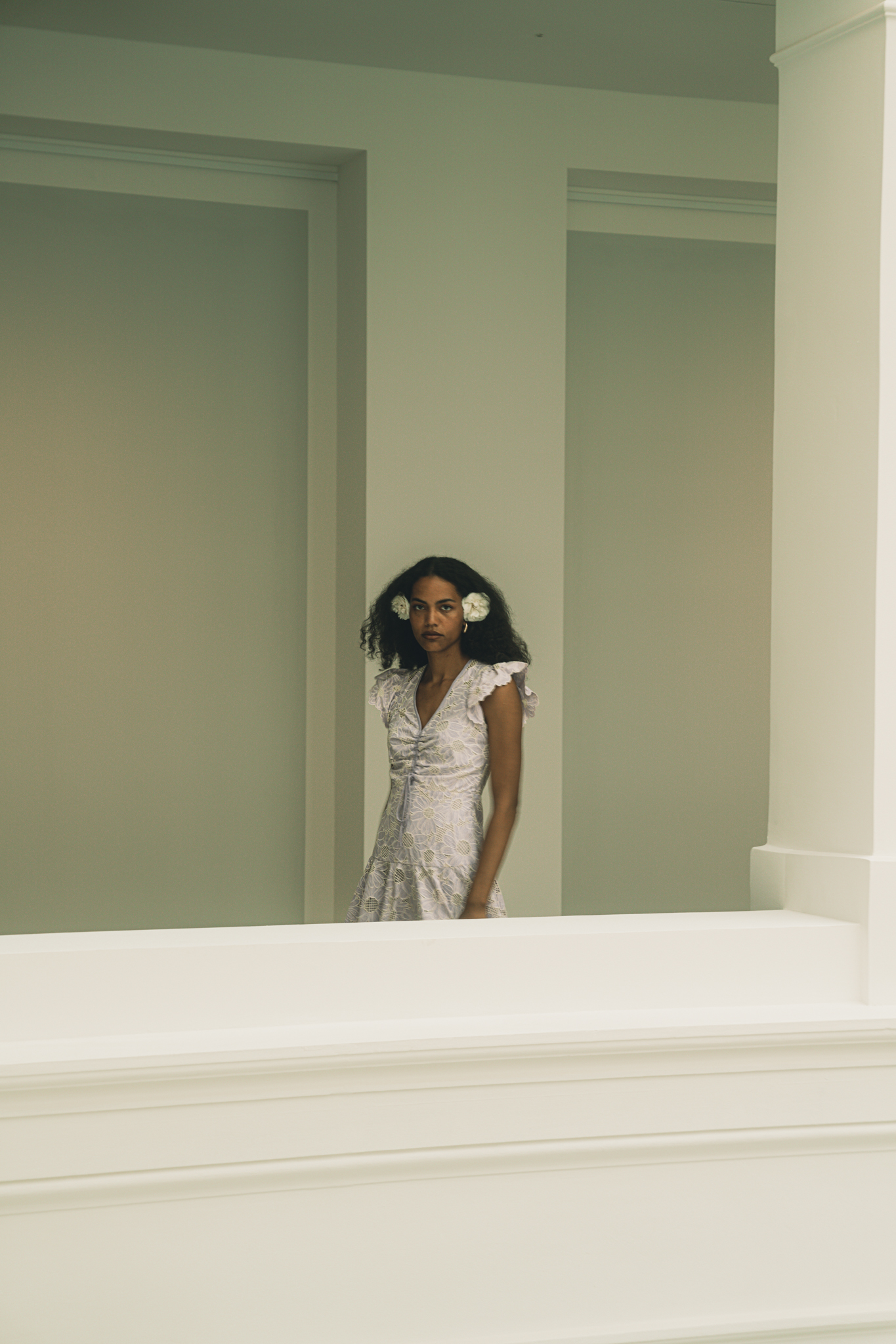 A Dance of Contradictions by FADETOBLACK, fine art portrait photography, image 23: Portraits of a woman with voluminous curly hair in a short ruffled lilac lace dress, moving between bright
