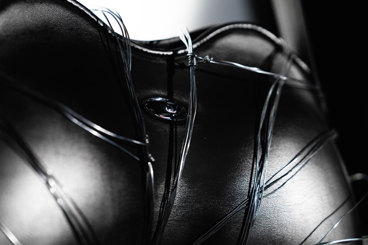 DIESEL x DUST MAGAZINE by FADETOBLACK, still life campaign photography, image 10: High-contrast, near-monochrome still life series shot in a dark studio: fashion accessories such as heeled