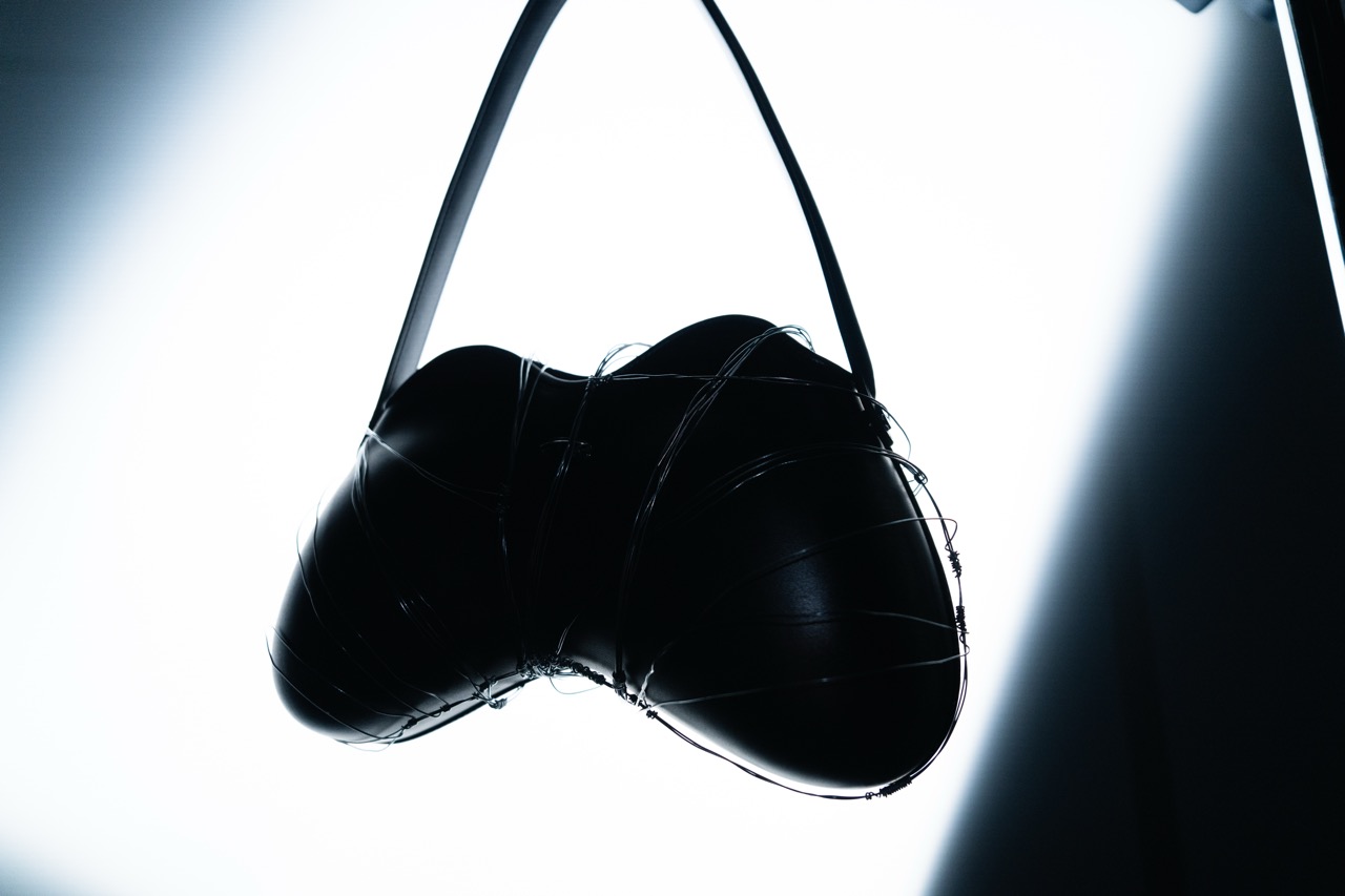DIESEL x DUST MAGAZINE by FADETOBLACK, still life campaign photography, image 7: High-contrast, near-monochrome still life series shot in a dark studio: fashion accessories such as heeled