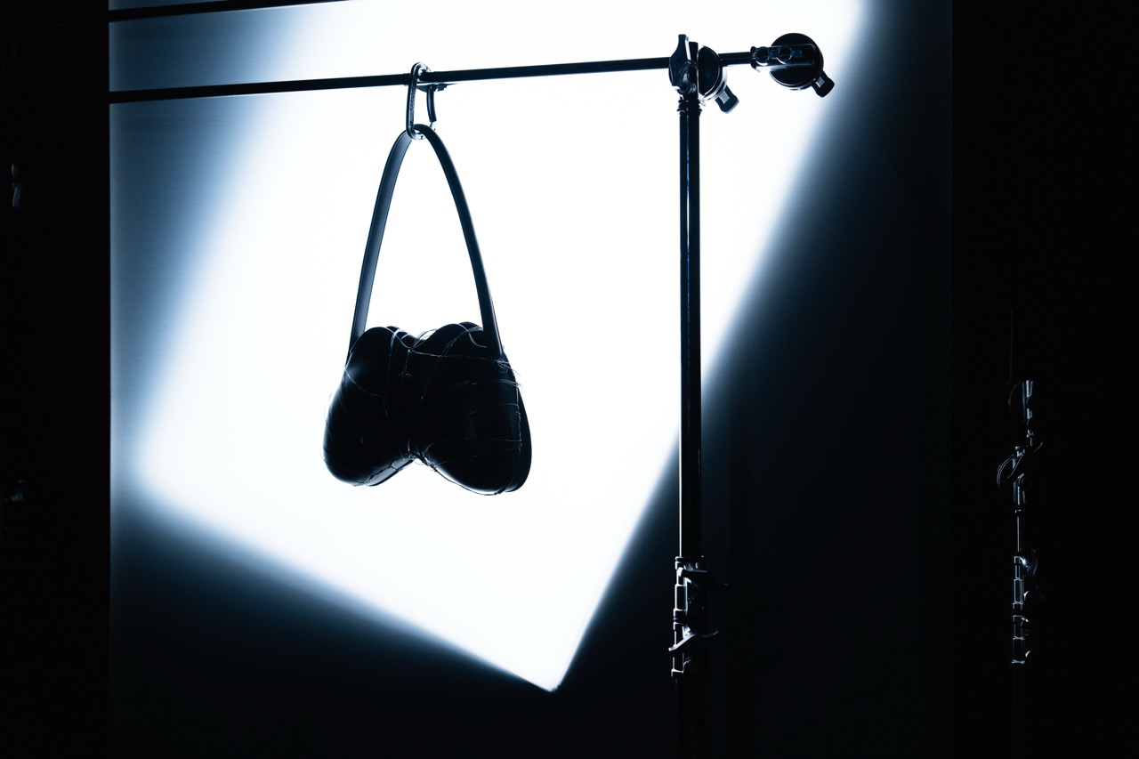 DIESEL x DUST MAGAZINE by FADETOBLACK, still life campaign photography, image 8: High-contrast, near-monochrome still life series shot in a dark studio: fashion accessories such as heeled