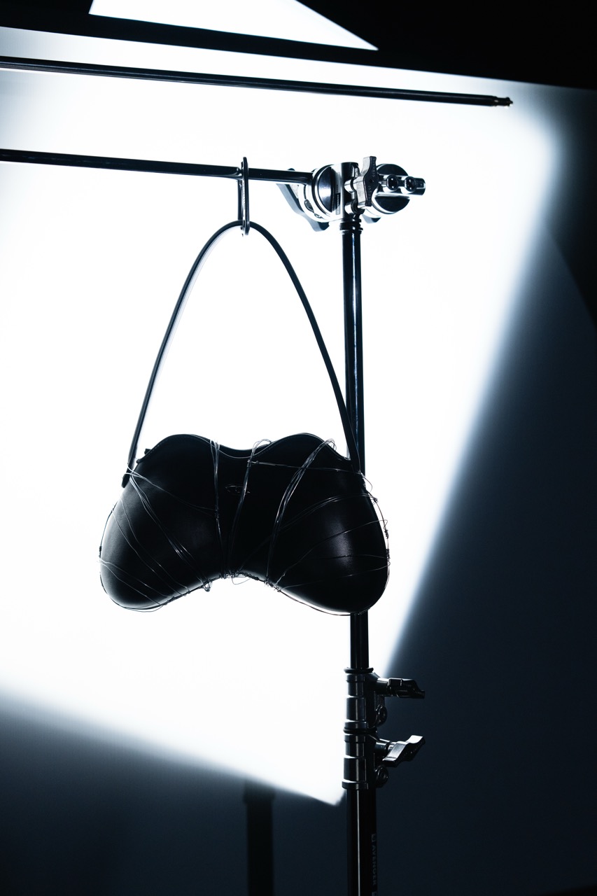 DIESEL x DUST MAGAZINE by FADETOBLACK, still life campaign photography, image 9: High-contrast, near-monochrome still life series shot in a dark studio: fashion accessories such as heeled
