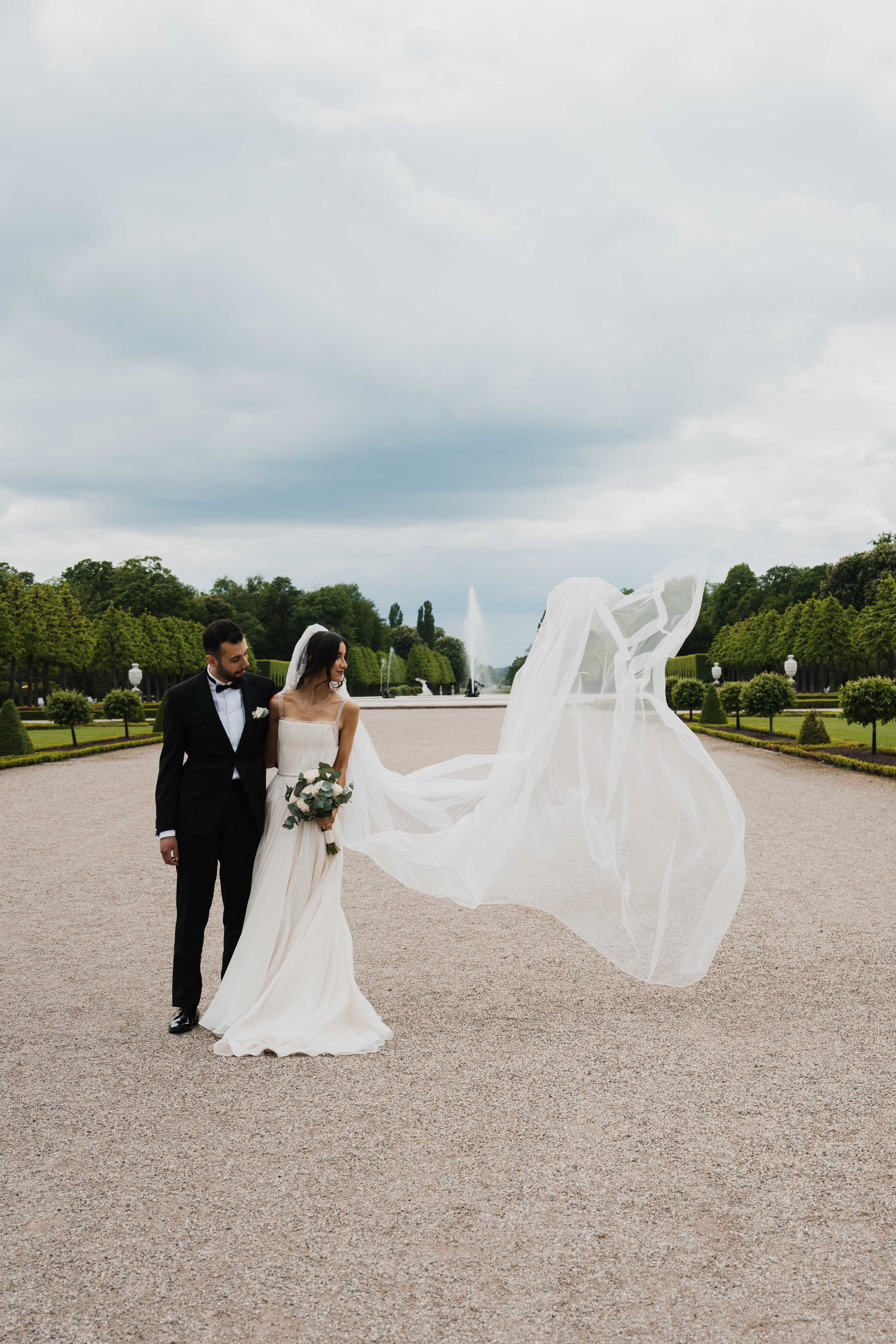 Eternal Moments: A Wedding Photography Collection by FADETOBLACK, wedding photography, image 11: Wedding series mixing black and white and color: a bride in a lace puff-sleeve dress beside a vintage car