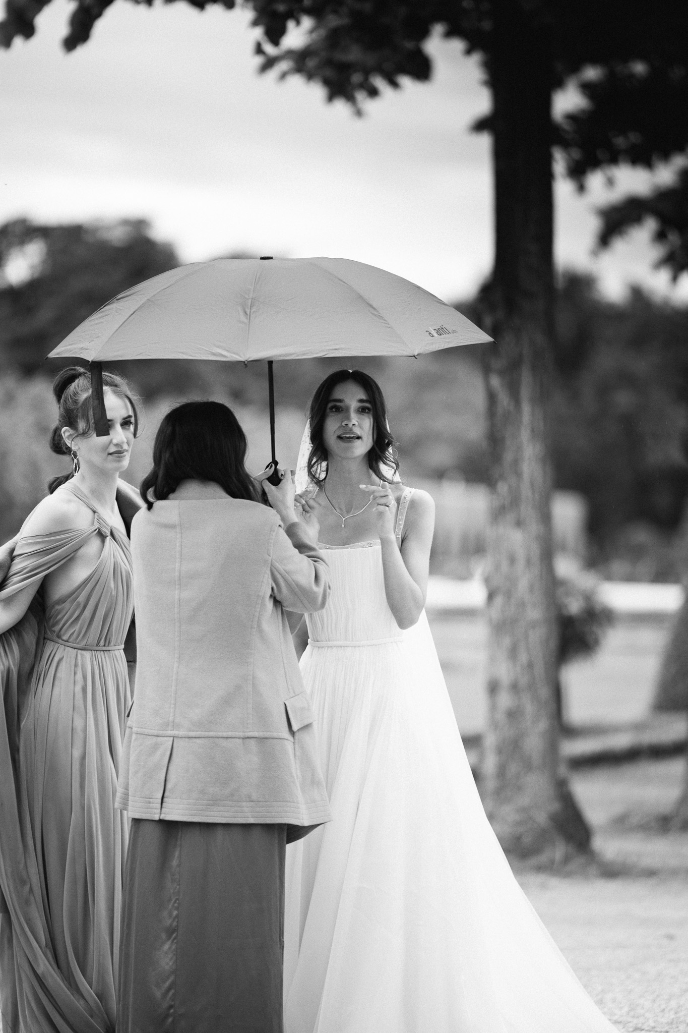 Eternal Moments: A Wedding Photography Collection by FADETOBLACK, wedding photography, image 18: Wedding series mixing black and white and color: a bride in a lace puff-sleeve dress beside a vintage car