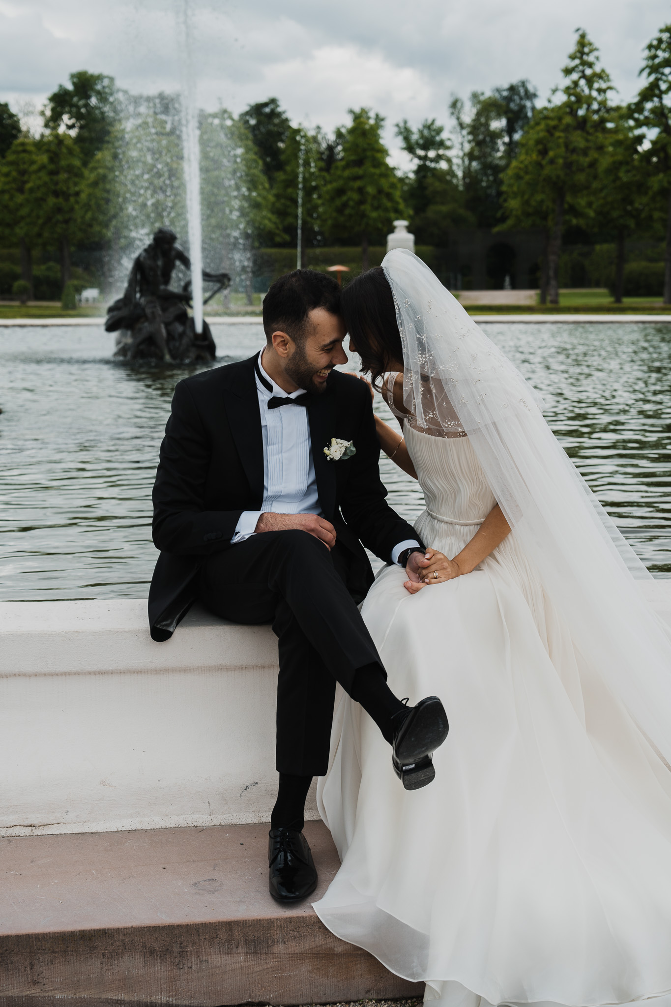 Eternal Moments: A Wedding Photography Collection by FADETOBLACK, wedding photography, image 14: Wedding series mixing black and white and color: a bride in a lace puff-sleeve dress beside a vintage car
