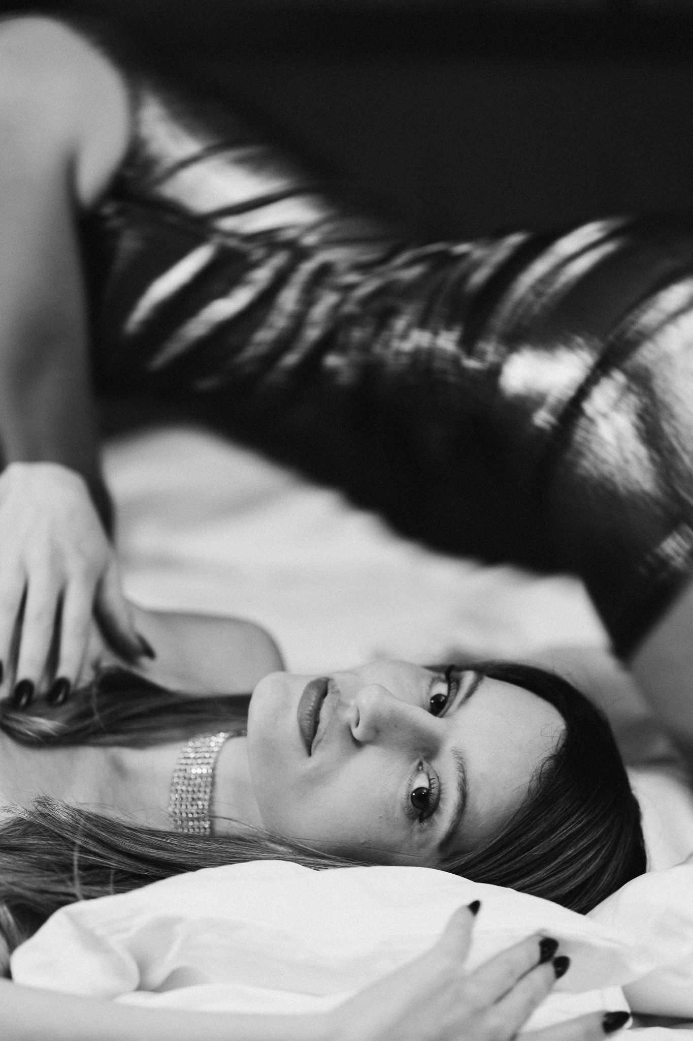 Heartless by FADETOBLACK, editorial fashion photography, image 13: Nighttime hotel editorial with two models in metallic gold and black mini dresses and thigh-high boots,
