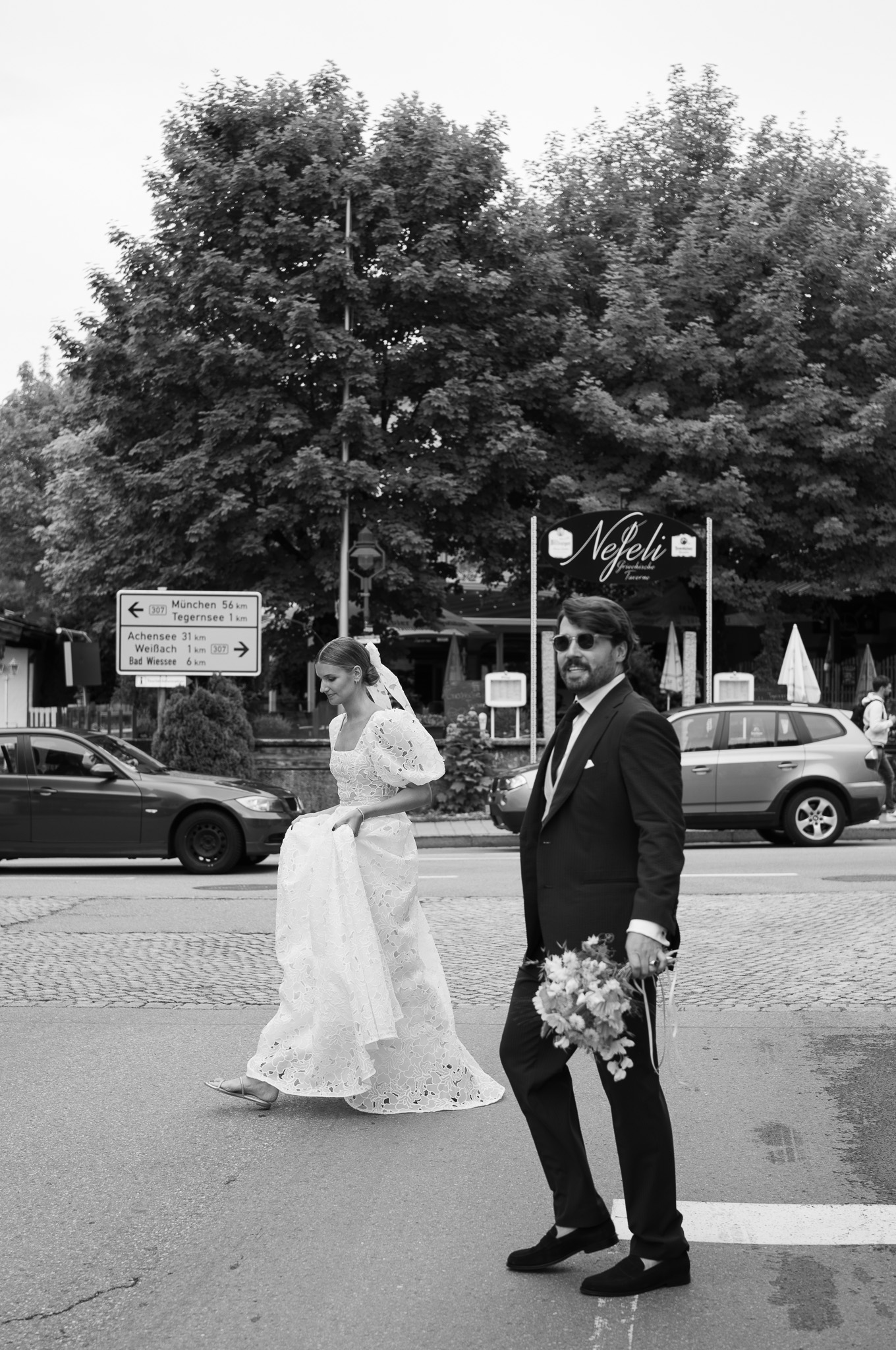 Eternal Moments: A Wedding Photography Collection by FADETOBLACK, wedding photography, image 27: Wedding series mixing black and white and color: a bride in a lace puff-sleeve dress beside a vintage car