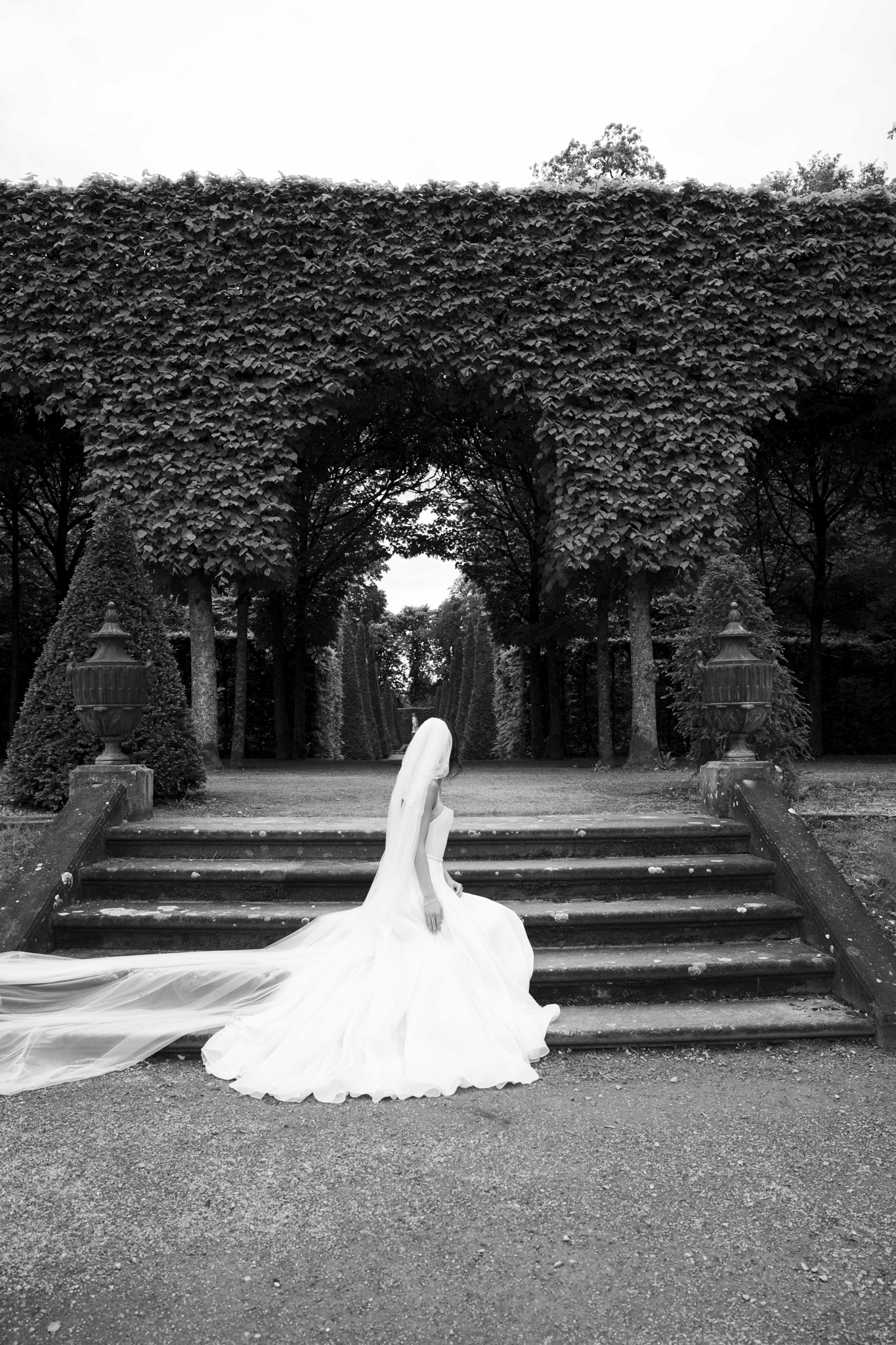 Eternal Moments: A Wedding Photography Collection by FADETOBLACK, wedding photography, image 33: Wedding series mixing black and white and color: a bride in a lace puff-sleeve dress beside a vintage car