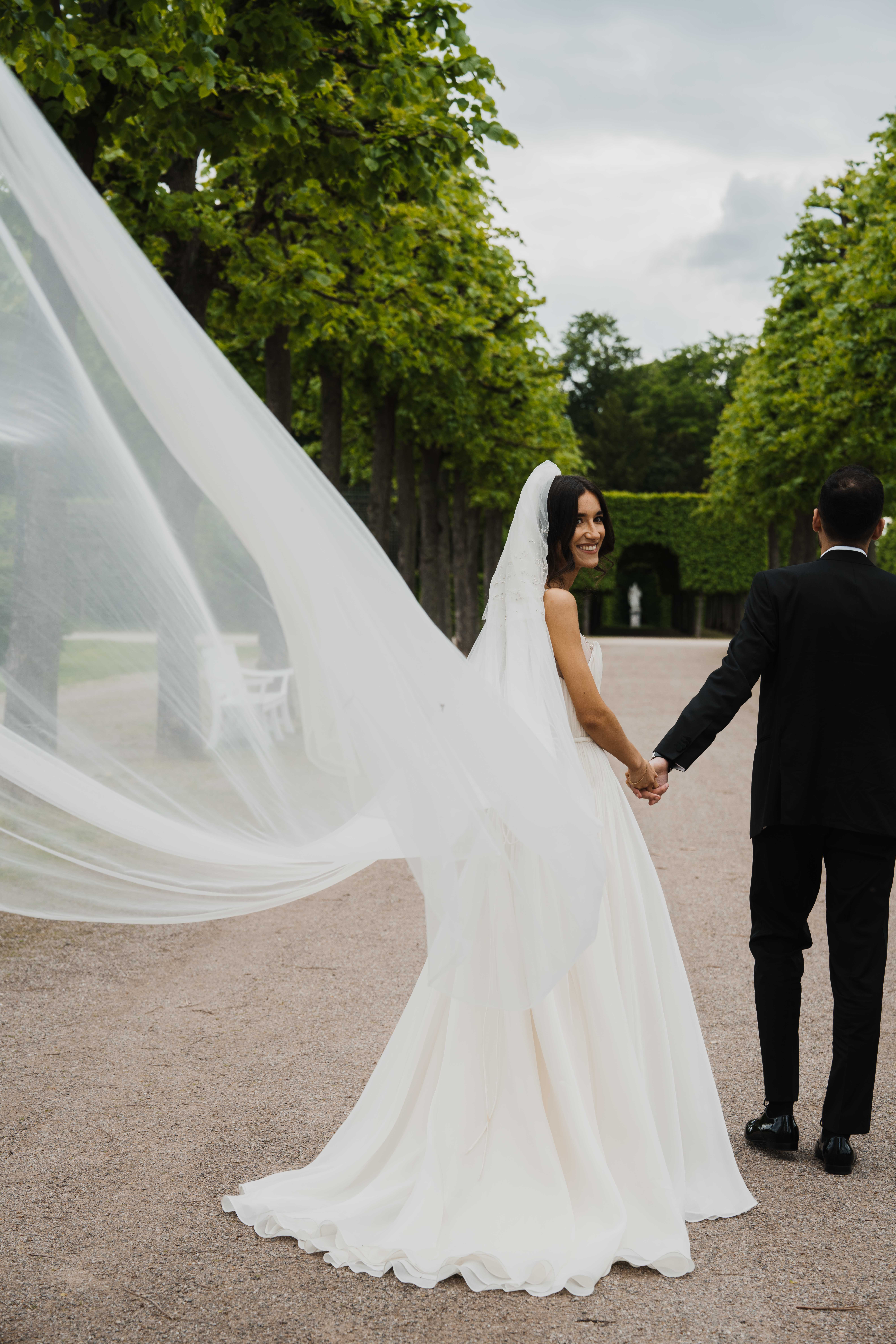 Eternal Moments: A Wedding Photography Collection by FADETOBLACK, wedding photography, image 12: Wedding series mixing black and white and color: a bride in a lace puff-sleeve dress beside a vintage car