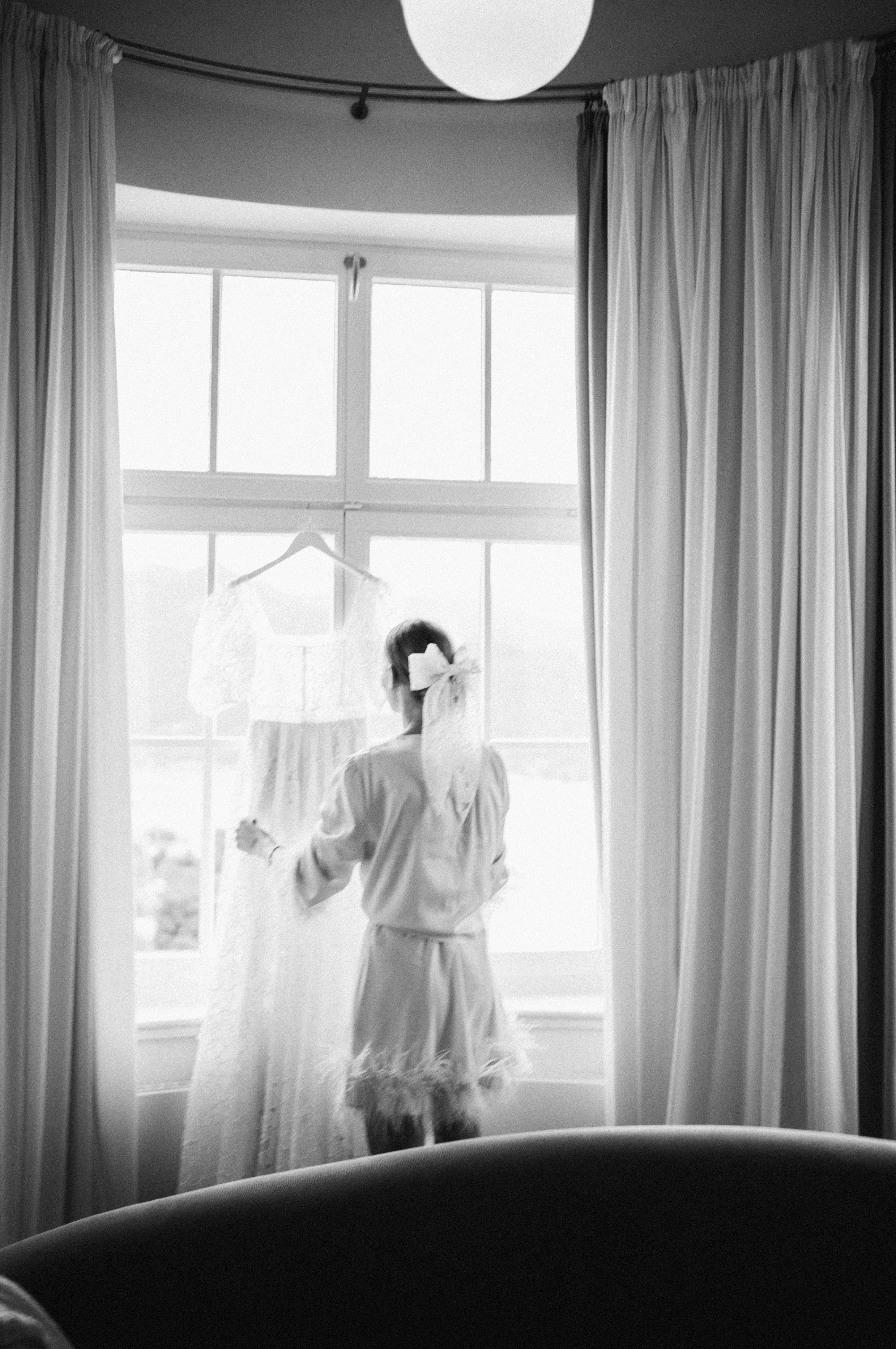 Eternal Moments: A Wedding Photography Collection by FADETOBLACK, wedding photography, image 24: Wedding series mixing black and white and color: a bride in a lace puff-sleeve dress beside a vintage car
