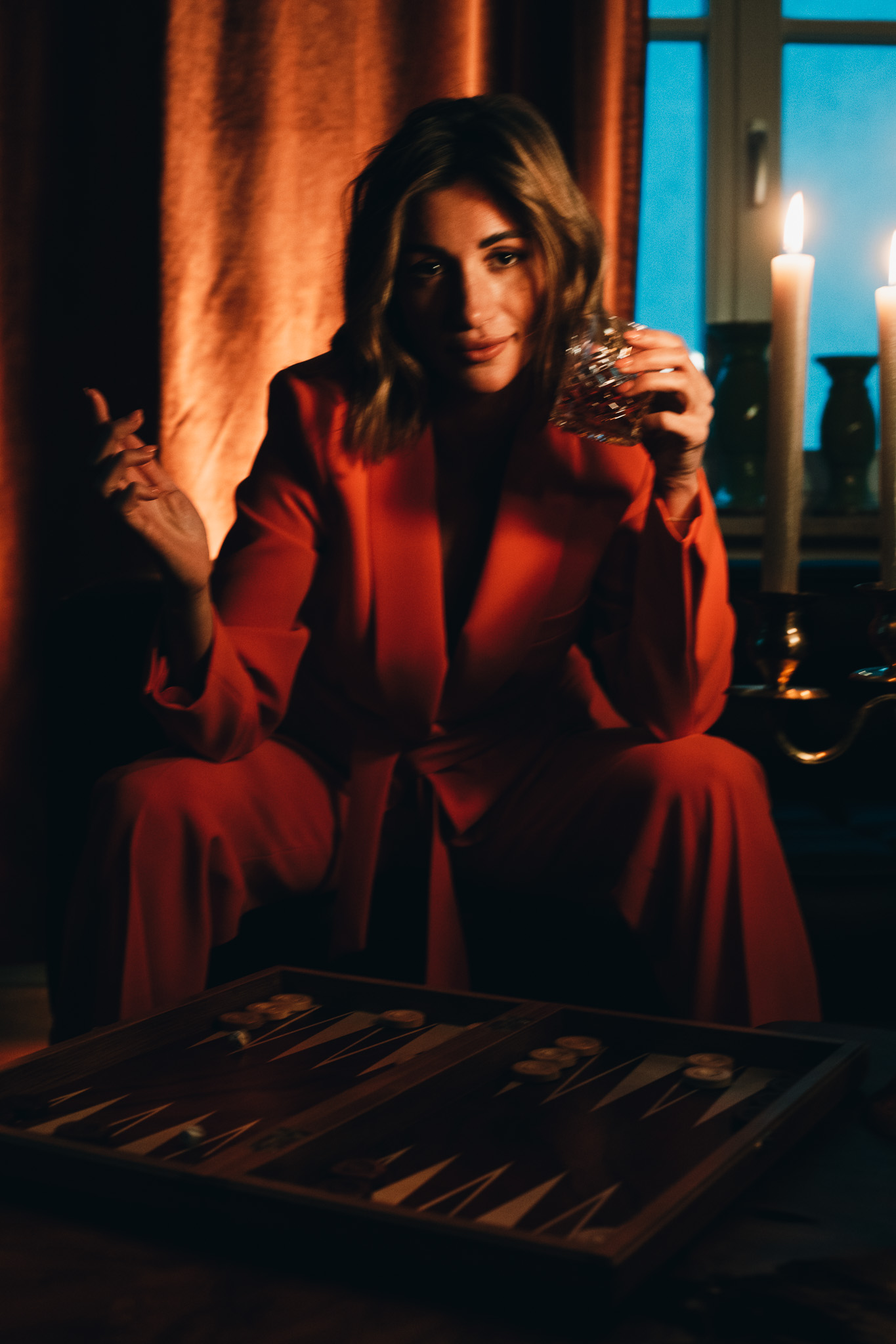 Chiara by FADETOBLACK, portrait photography, image 1: Cinematic low-light portraits of a woman in warm interiors: lying on an oriental rug surrounded by a
