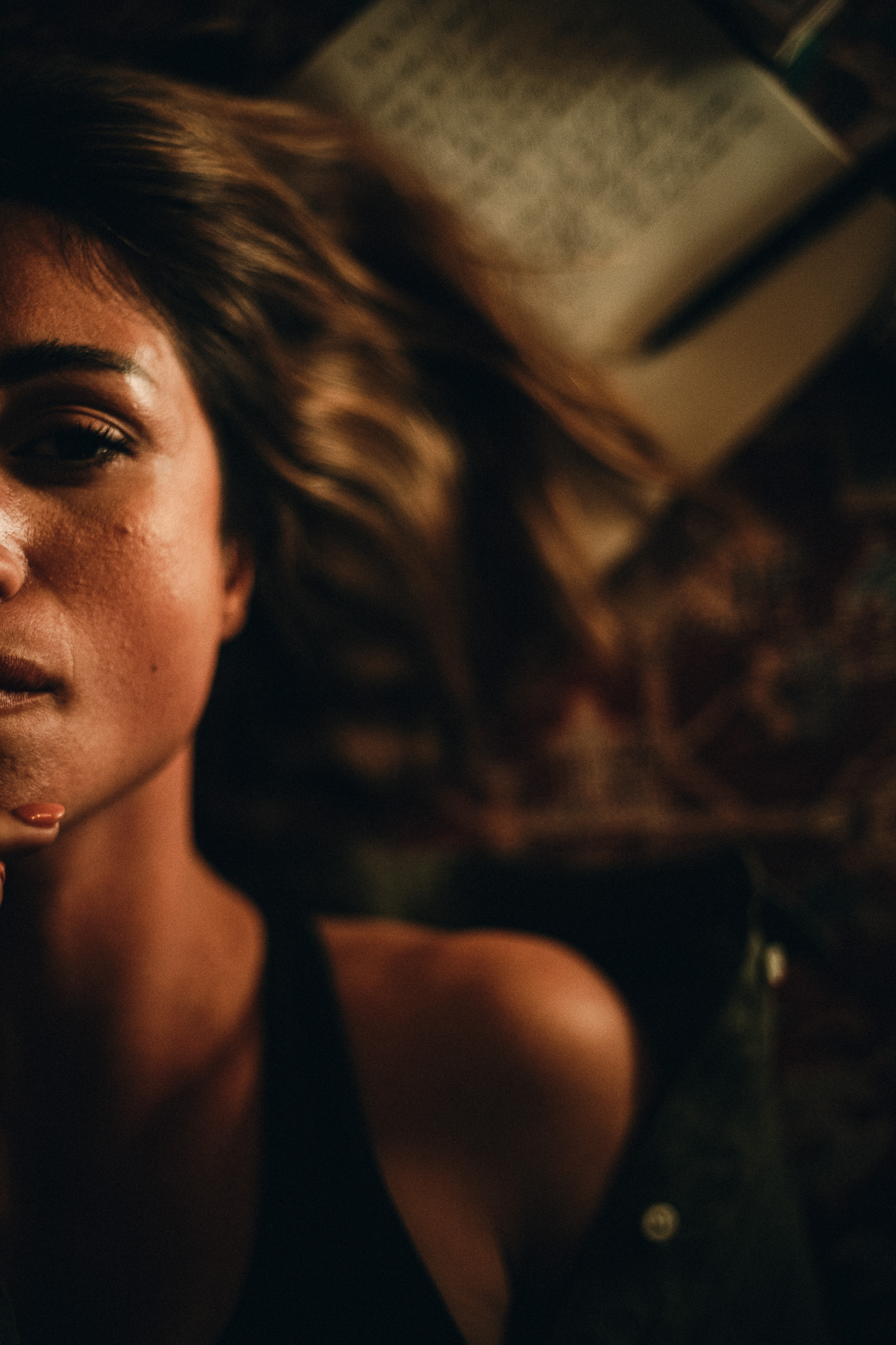 Chiara by FADETOBLACK, portrait photography, image 5: Cinematic low-light portraits of a woman in warm interiors: lying on an oriental rug surrounded by a