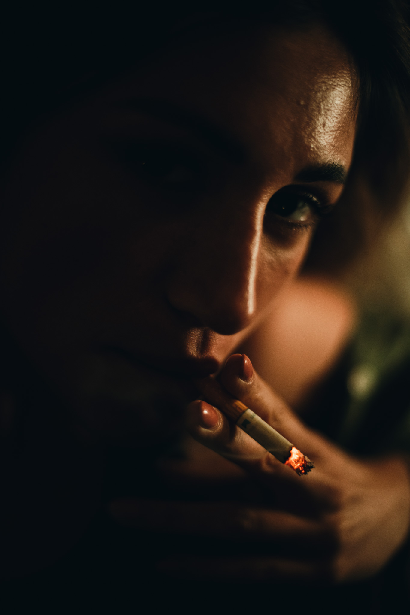 Chiara by FADETOBLACK, portrait photography, image 6: Cinematic low-light portraits of a woman in warm interiors: lying on an oriental rug surrounded by a