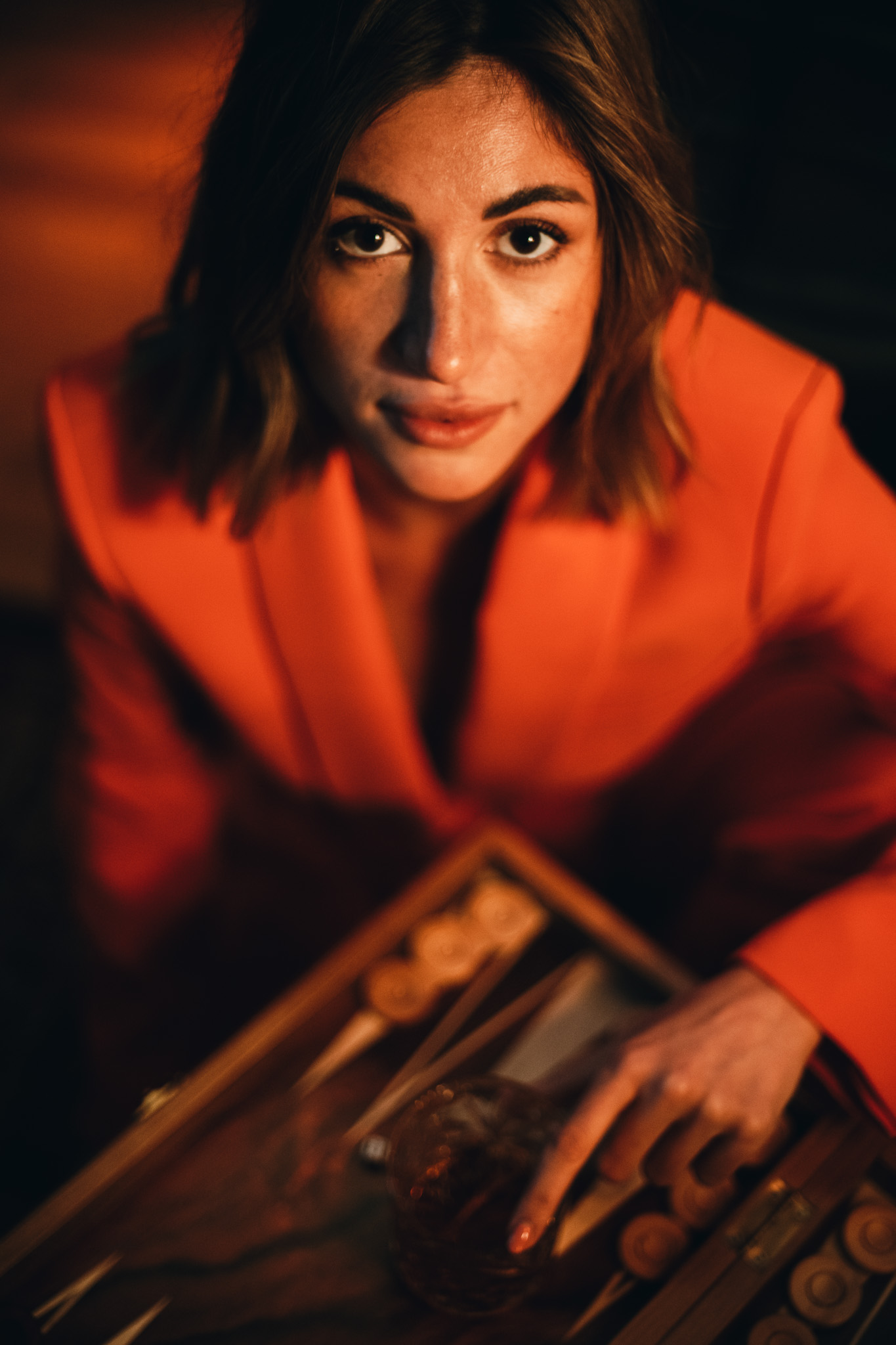 Chiara by FADETOBLACK, portrait photography, image 3: Cinematic low-light portraits of a woman in warm interiors: lying on an oriental rug surrounded by a