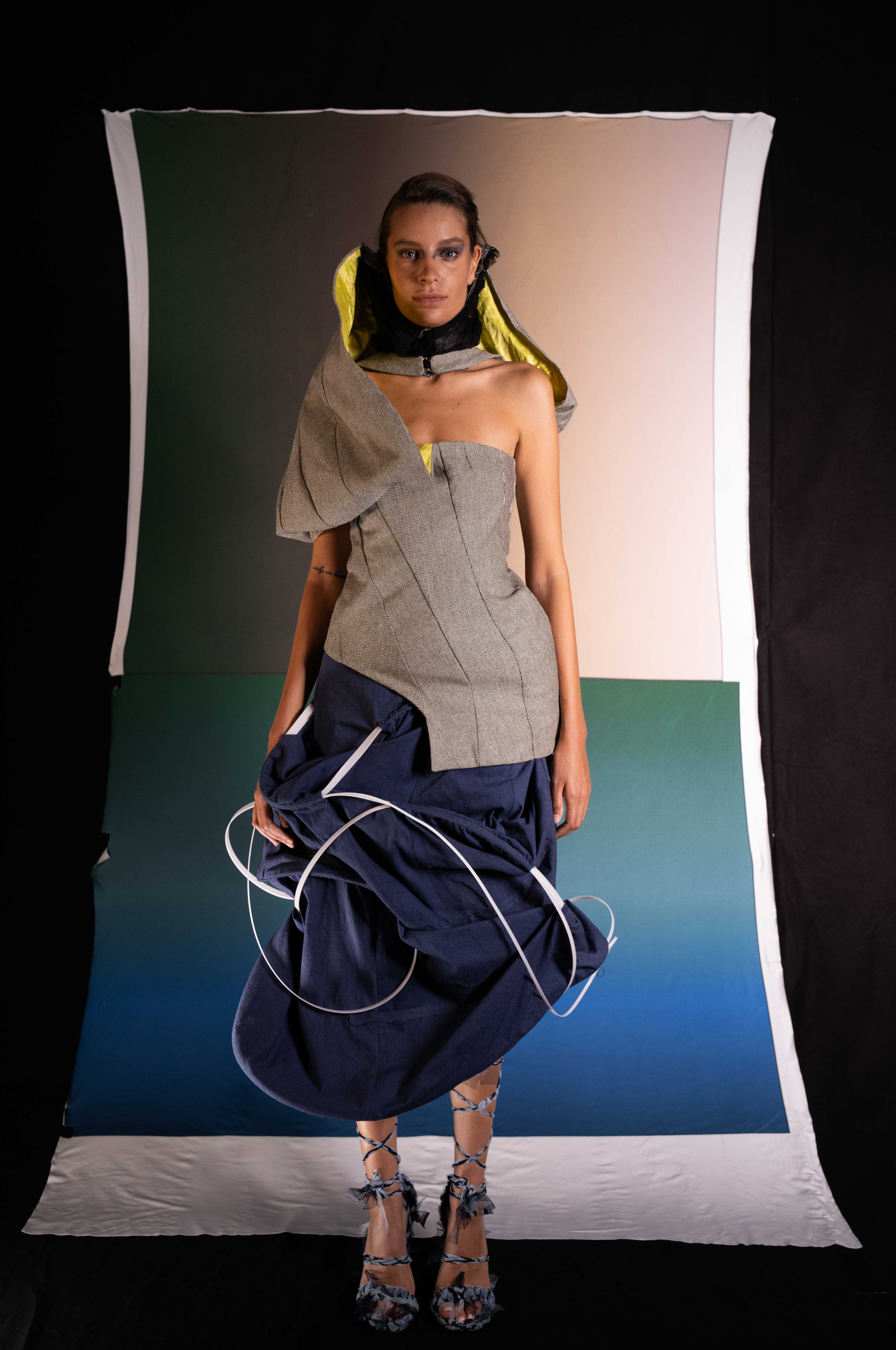 Laurin Schuler by FADETOBLACK, fashion editorial photography, image 8: Studio editorial for a designer collection: models wear sculptural hooded collar pieces in grey and