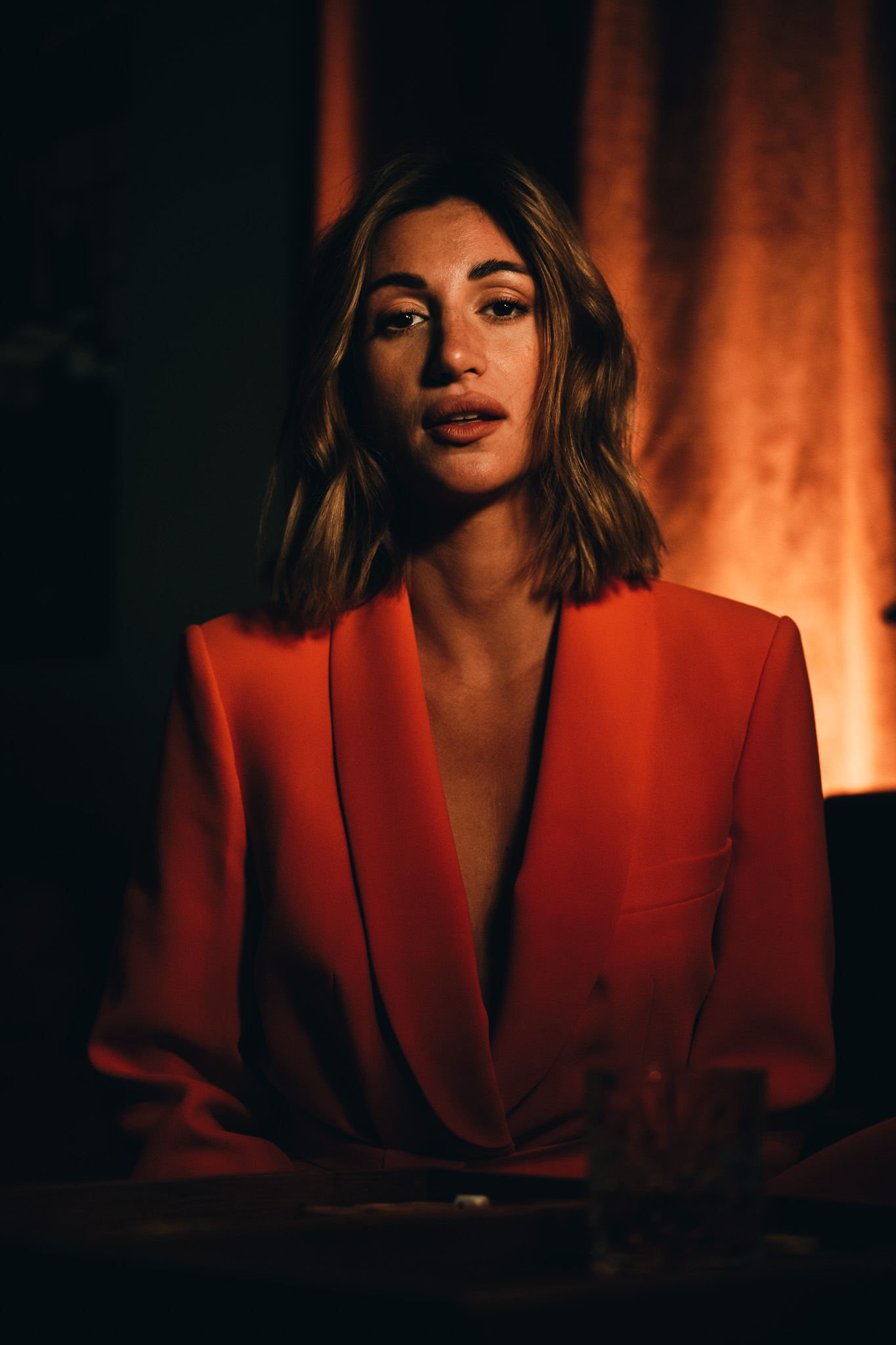 Chiara by FADETOBLACK, portrait photography, image 2: Cinematic low-light portraits of a woman in warm interiors: lying on an oriental rug surrounded by a