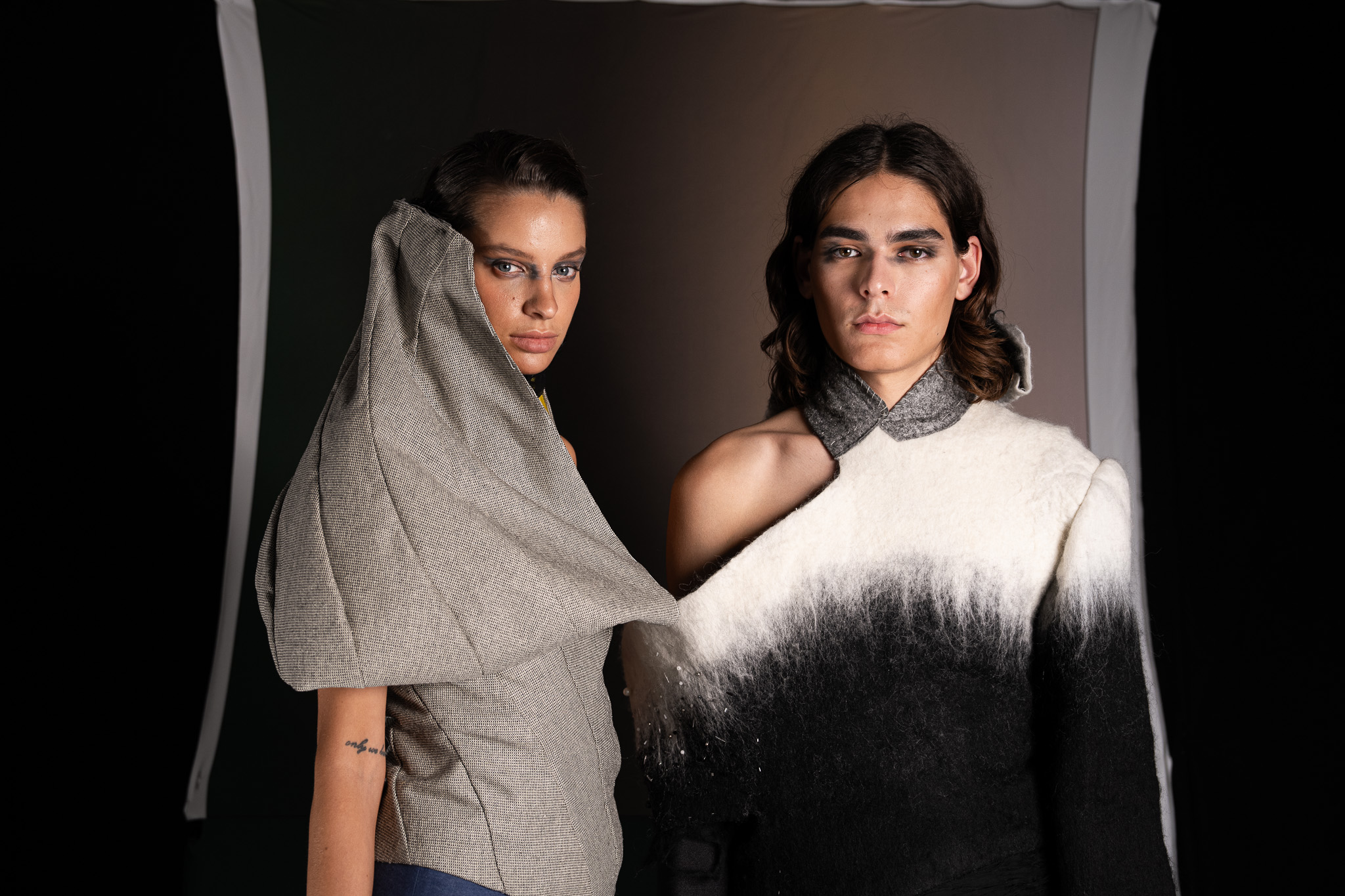 Laurin Schuler by FADETOBLACK, fashion editorial photography, image 22: Studio editorial for a designer collection: models wear sculptural hooded collar pieces in grey and