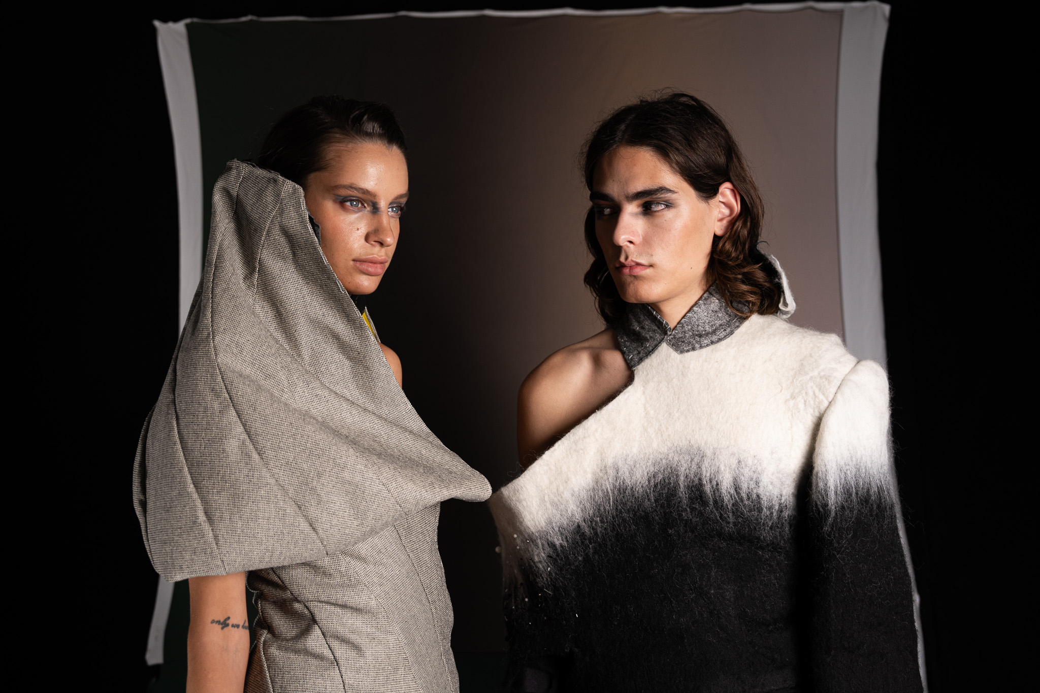 Laurin Schuler by FADETOBLACK, fashion editorial photography, image 21: Studio editorial for a designer collection: models wear sculptural hooded collar pieces in grey and