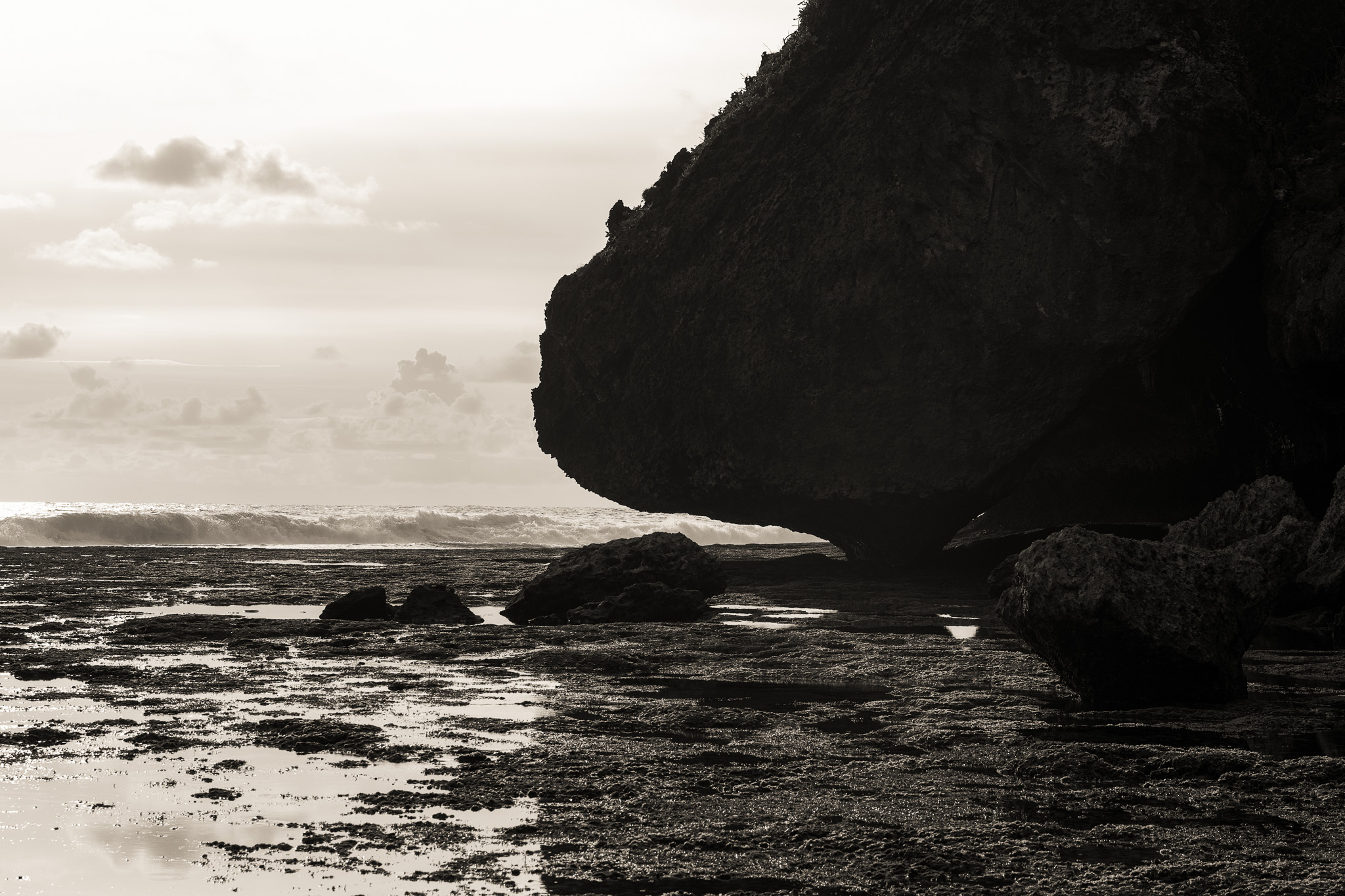 Islands of Contrast: The Indonesia Series by FADETOBLACK, travel photography, image 24: Travel and documentary scenes from Indonesia: a sepia-toned view of a motorcyclist riding under a tunnel of