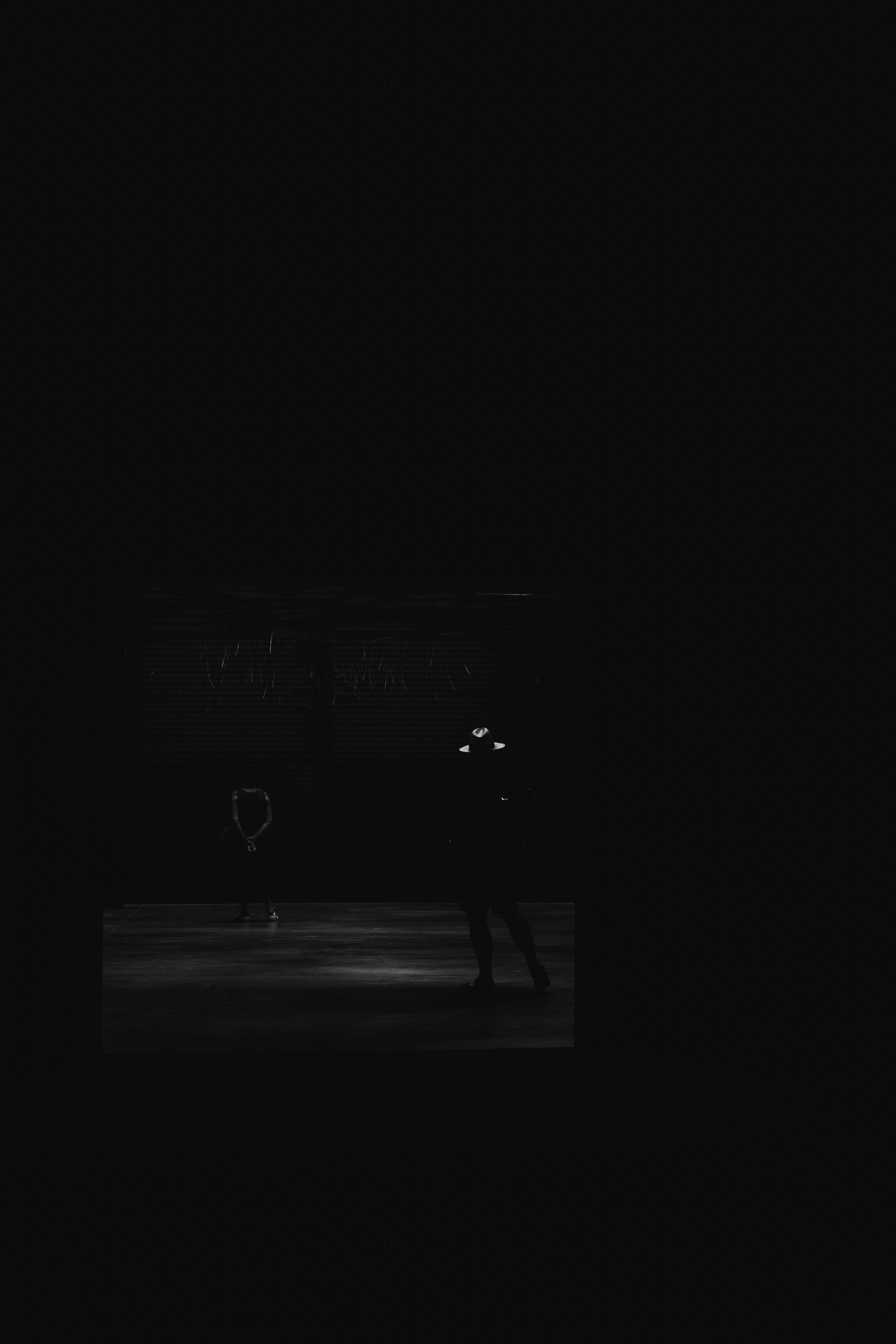 Venice in the Shadows by FADETOBLACK, fine art street photography, image 14: High-contrast black and white night scenes in Venice: a lone man walking across a dark square past an ornate