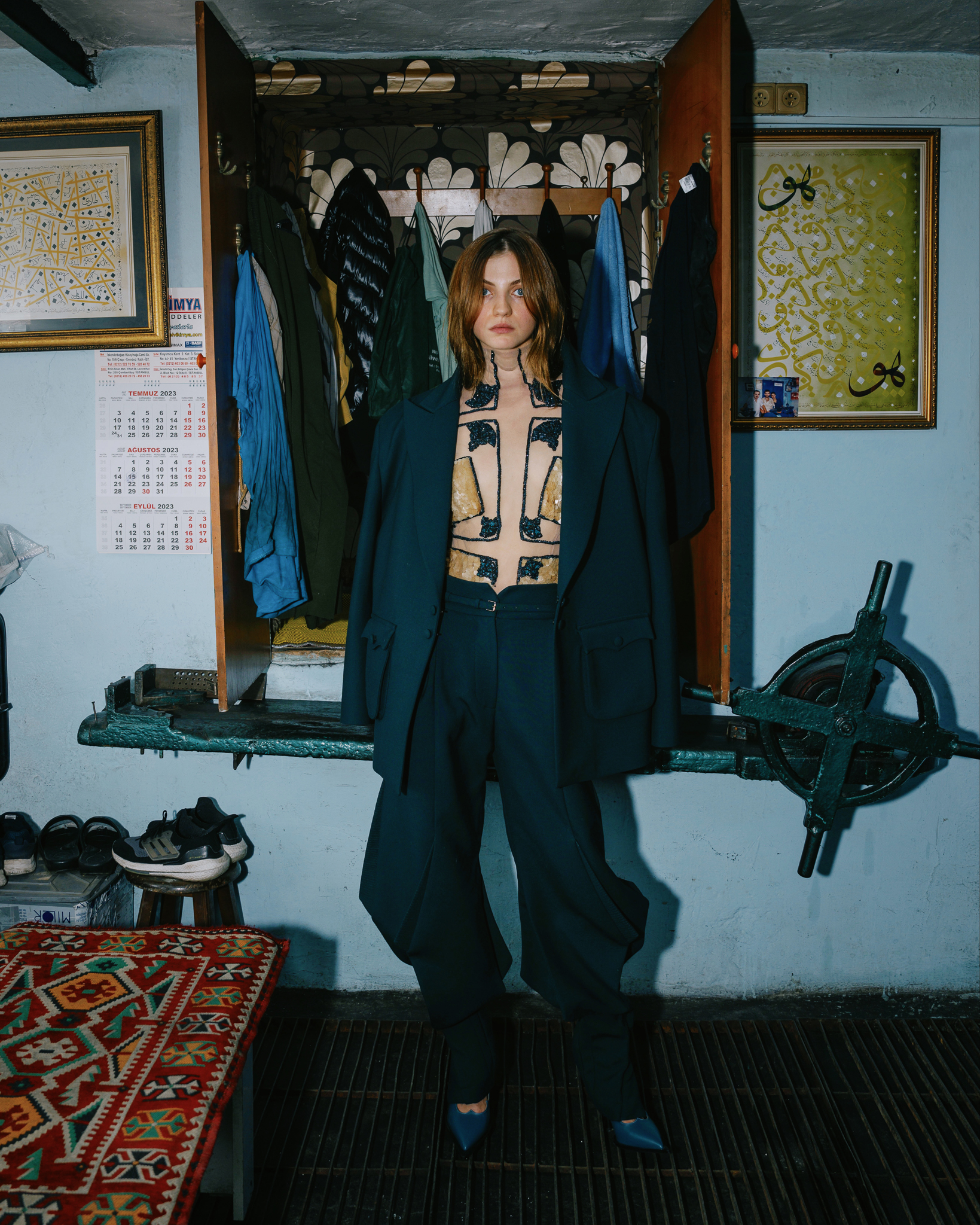 Tayfun Kaba by FADETOBLACK, editorial fashion photography, image 9: Editorial fashion shoot on busy Istanbul streets: models stand motionless in an embroidered dark red gown, a