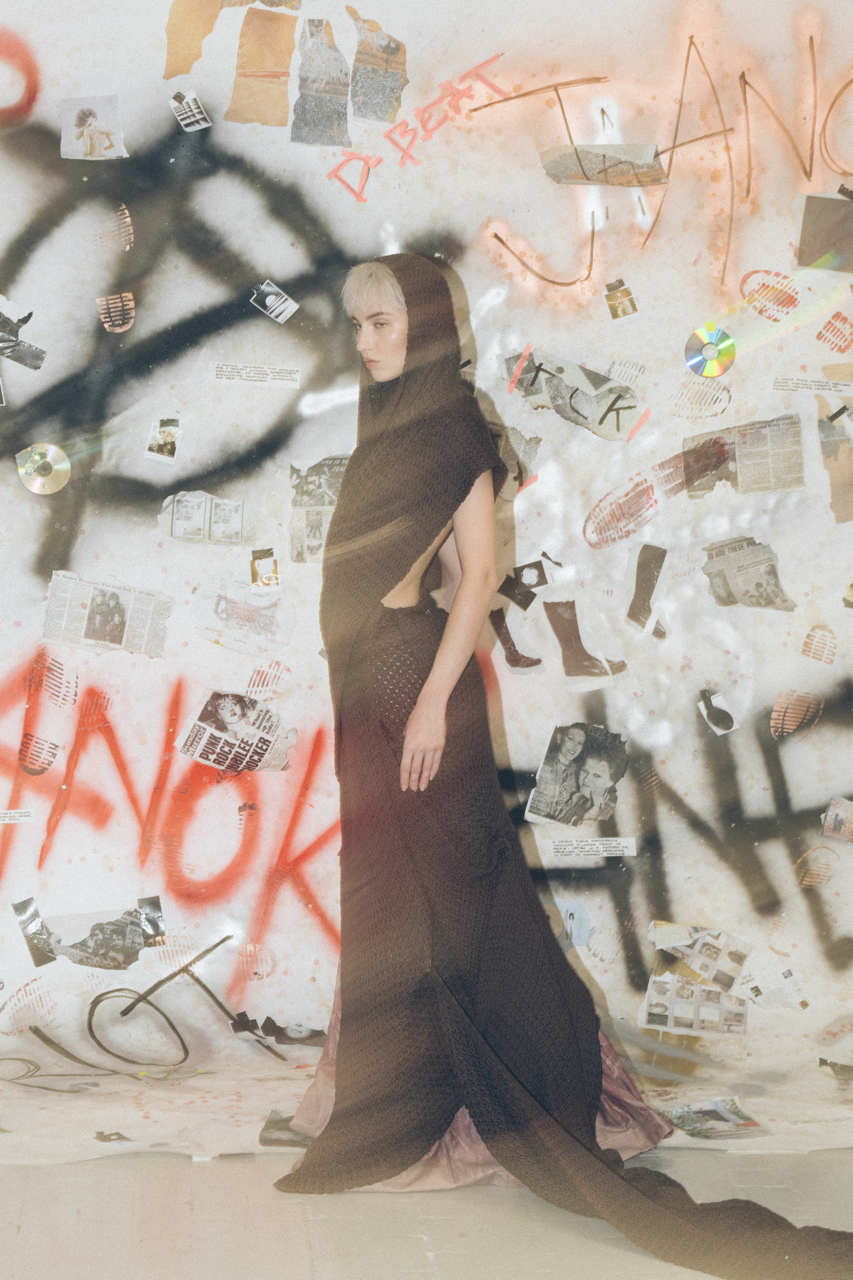 Jaang by FADETOBLACK, editorial fashion photography, image 23: Studio fashion editorial of a model with short platinum hair wearing avant-garde statement pieces, including