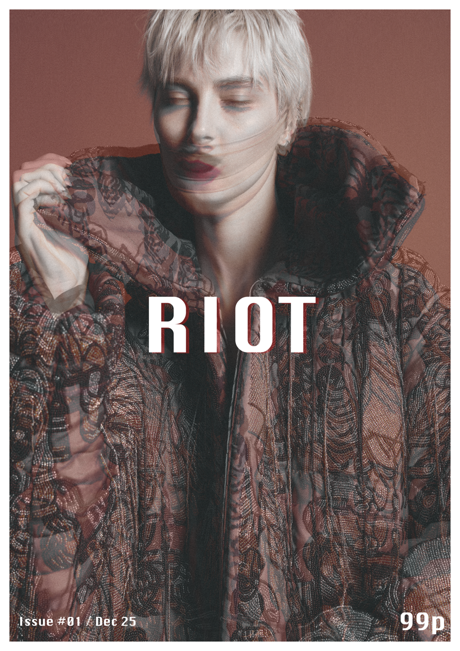 Jaang by FADETOBLACK, editorial fashion photography, image 11: Studio fashion editorial of a model with short platinum hair wearing avant-garde statement pieces, including
