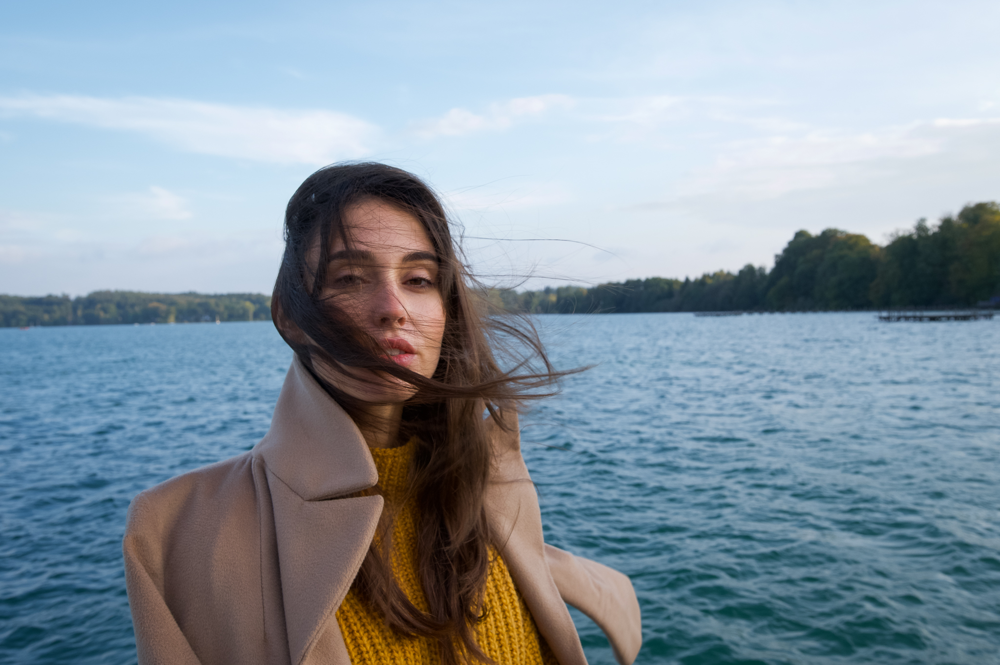 Emily: Autumn Elegance by FADETOBLACK, outdoor portrait photography, image 9: Autumn lakeside portrait series of a young woman with long brown hair wearing a mustard yellow knit and dress