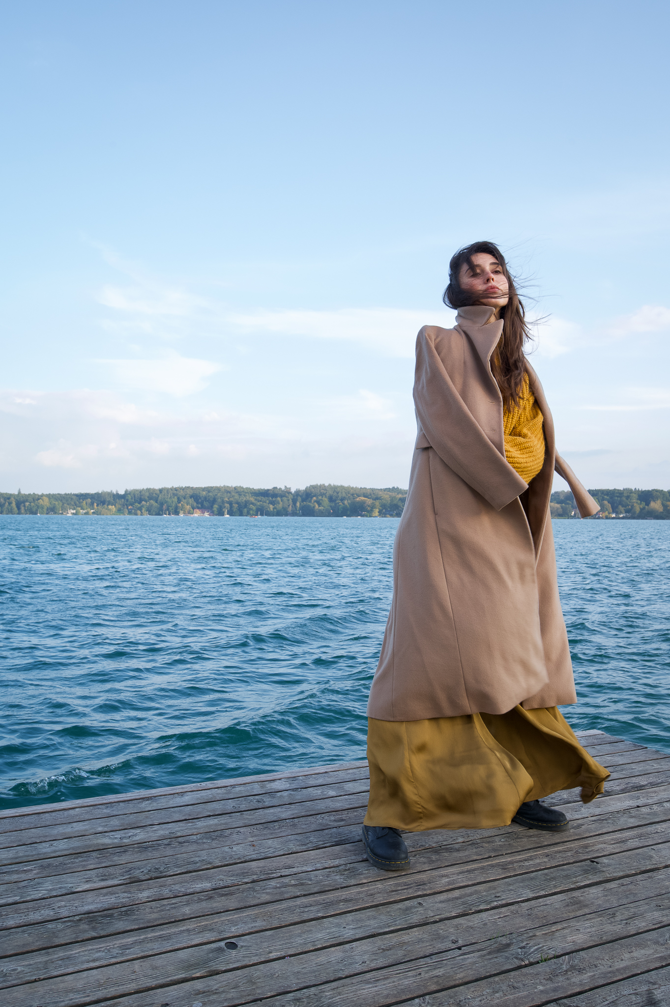Emily: Autumn Elegance by FADETOBLACK, outdoor portrait photography, image 1: Autumn lakeside portrait series of a young woman with long brown hair wearing a mustard yellow knit and dress