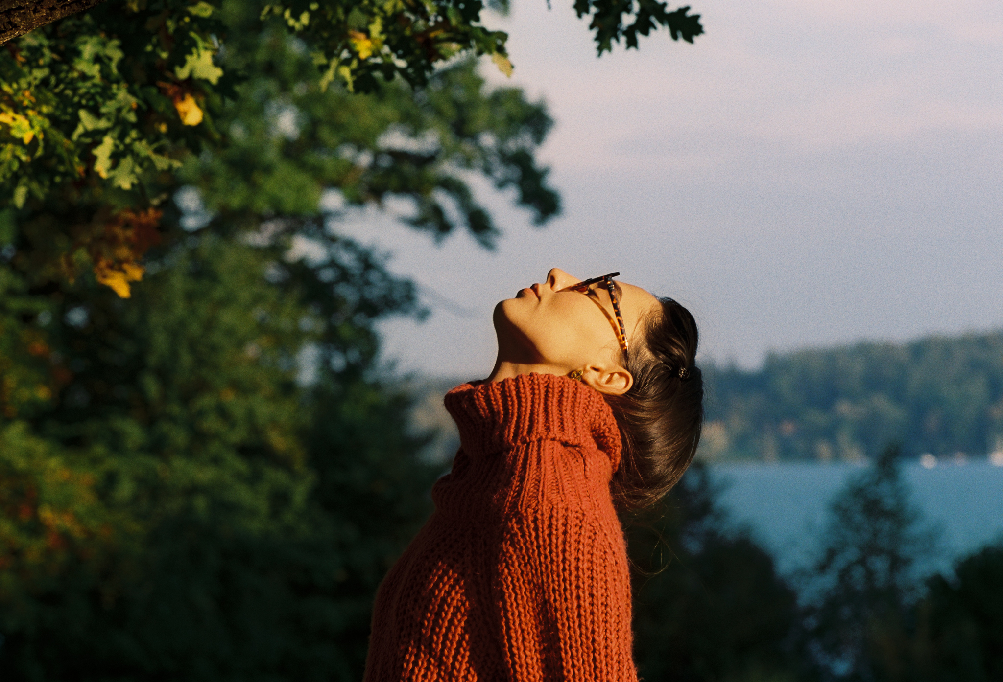 Emily: Autumn Elegance by FADETOBLACK, outdoor portrait photography, image 12: Autumn lakeside portrait series of a young woman with long brown hair wearing a mustard yellow knit and dress