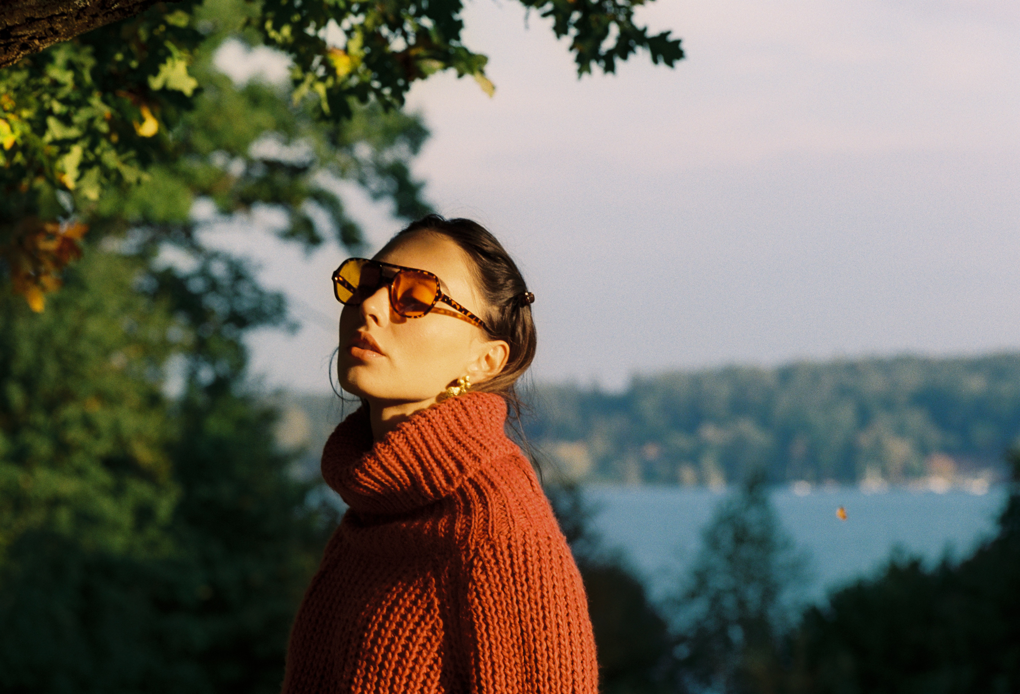 Emily: Autumn Elegance by FADETOBLACK, outdoor portrait photography, image 14: Autumn lakeside portrait series of a young woman with long brown hair wearing a mustard yellow knit and dress