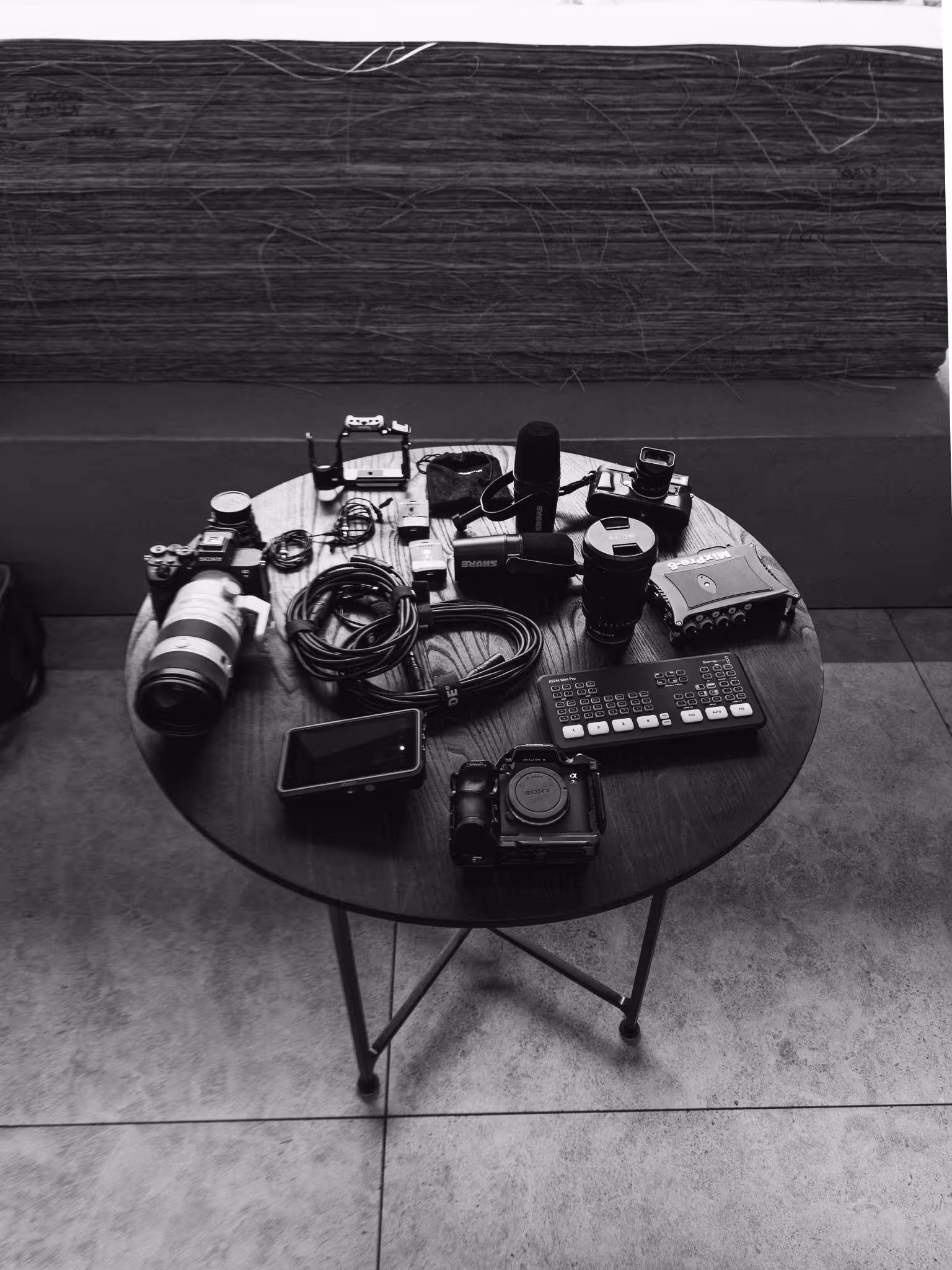 Table with camera bodies, lenses and a microphone before a shoot, symbolic image for posting frequency, FADETOBLACK Munich