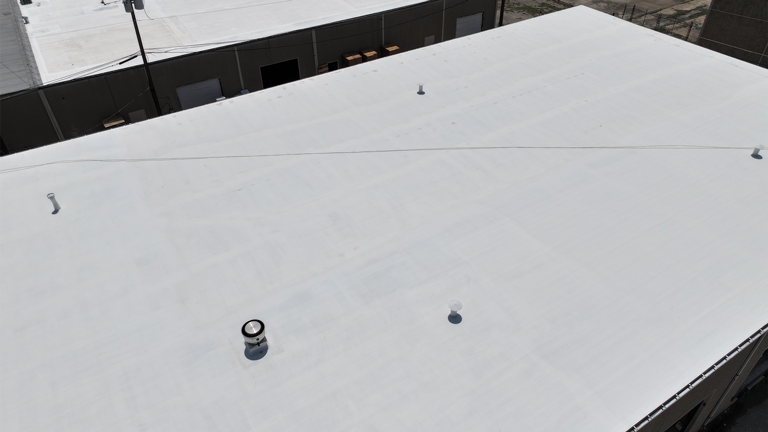 White commercial roof membrane with roof vents.