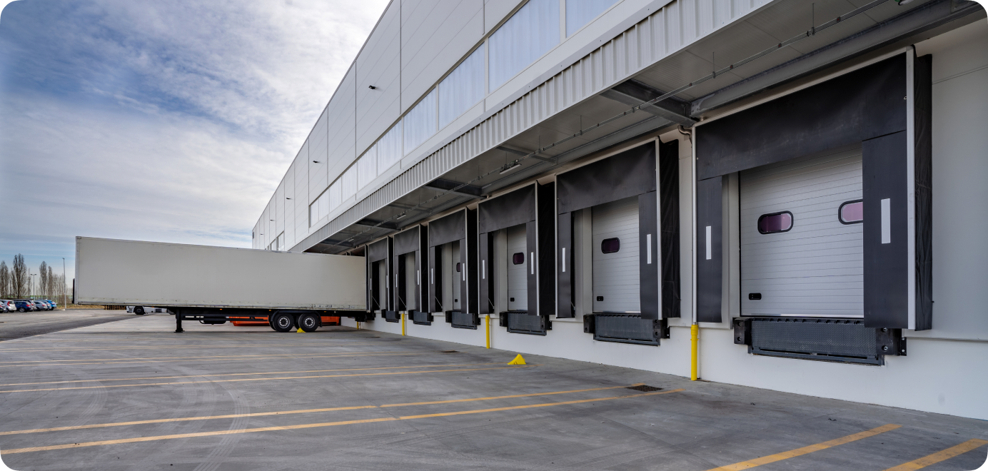 Commercial warehouse loading docks and light-colored exterior.