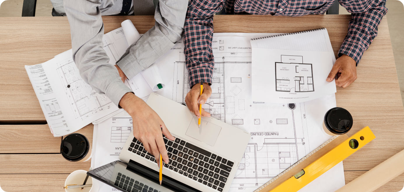 Construction professionals reviewing building plans and cost estimates.
