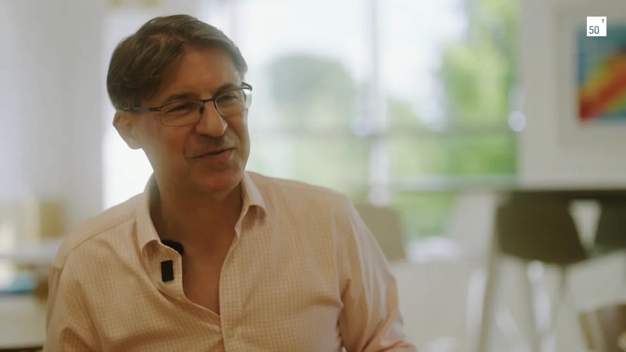 Mark Kotter in conversation, with the laboratory behind him.