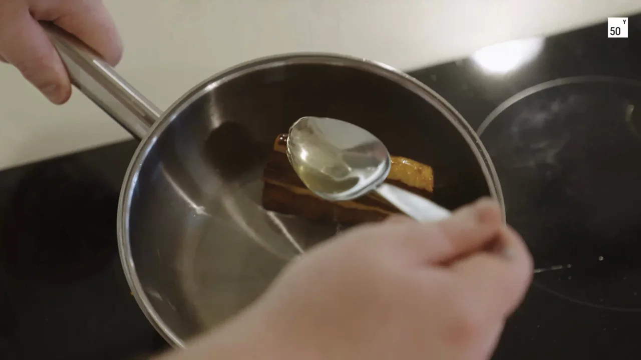 Hands work with a sample over a bowl in the Hoxton Farms kitchen.
