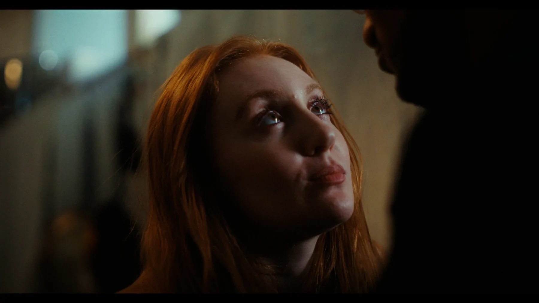 Indispensable - Grace looks up towards Nathan in warm interior light