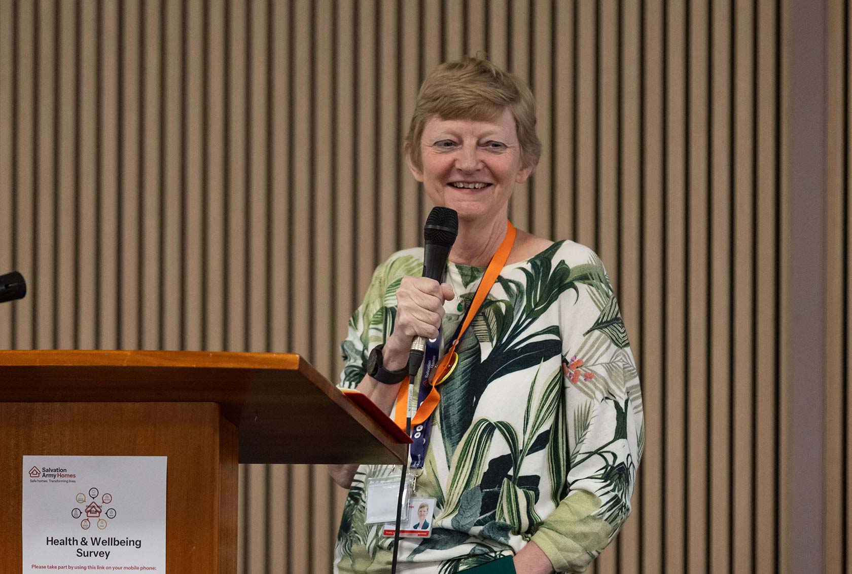 Salvation Army Homes CEO Lynne Shea giving a talk on a stage