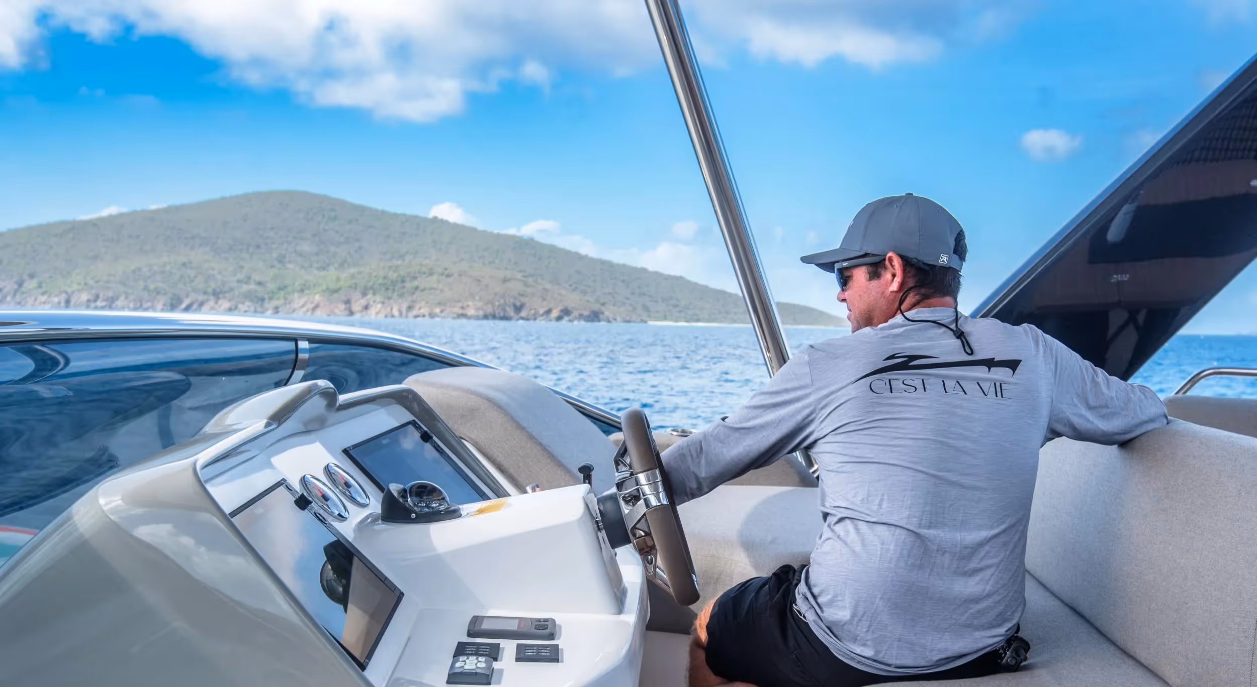 Captain at the helm of a crewed catamaran