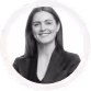 Black and white headshot of a smiling woman with long straight hair, wearing a dark blazer.