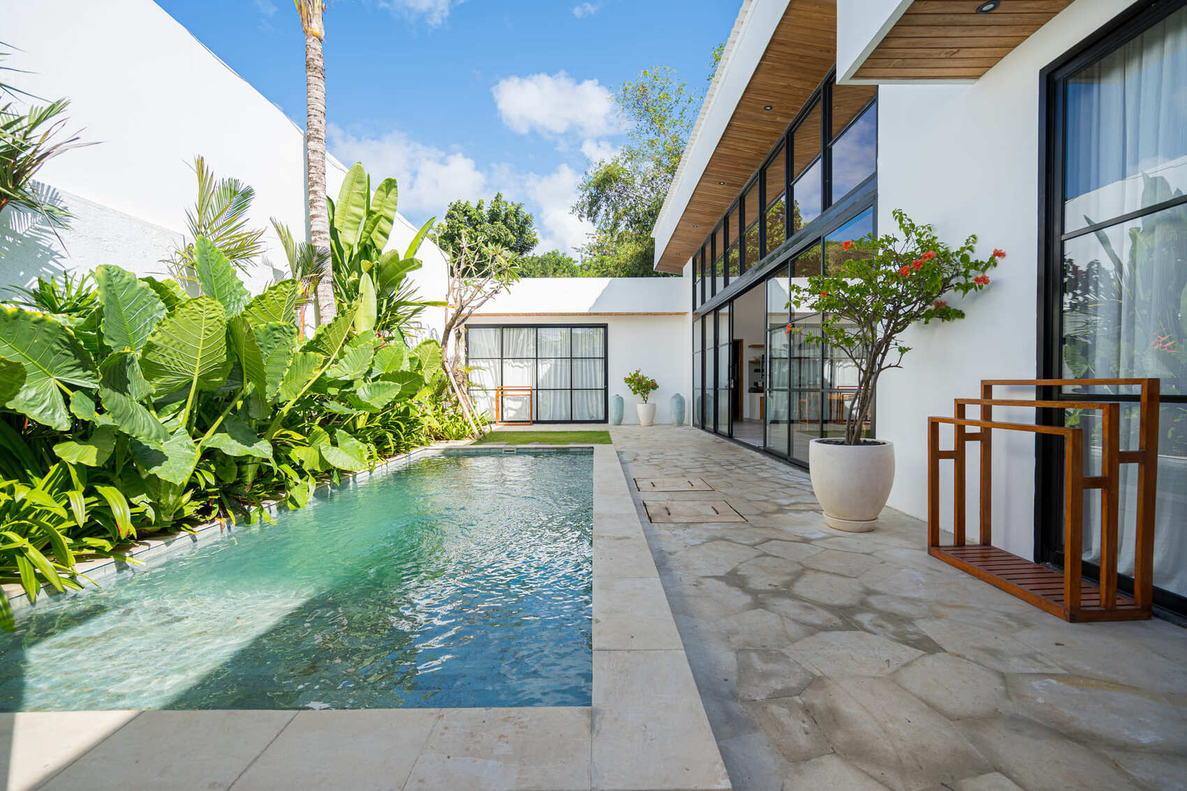 Modern Bali villa with pool and tropical garden, showcasing a premium Bali freehold property for sale.