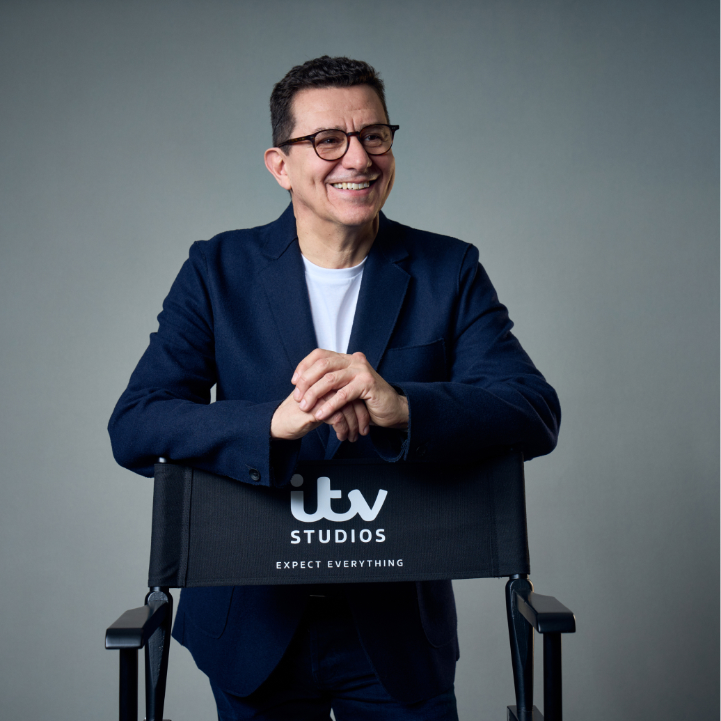 The text ‘Beyond the Screen’ is surrounded by neon signs featuring the titles of ITV Studios productions and related icons.