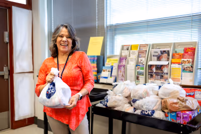 A Kentucky school teacher with God's Pantry Food Bank backpacks.