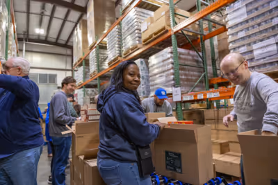 Volunteers help pack holiday food boxes at God's Pantry Food Bank.