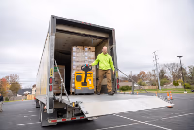 A God's Pantry staff member unloading a truck with nutritious food.