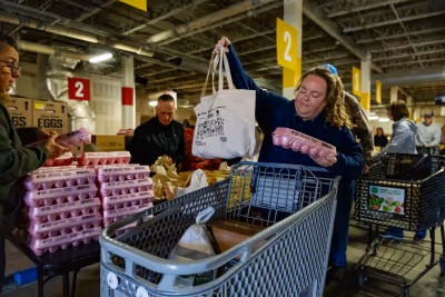 Volunteers helping to distribute holiday boxes at Sharing Thanksgiving.