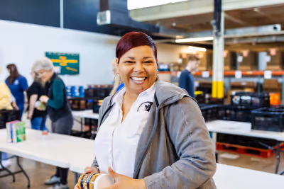 A volunteer helps pack boxes at our Lexington Volunteer Center.