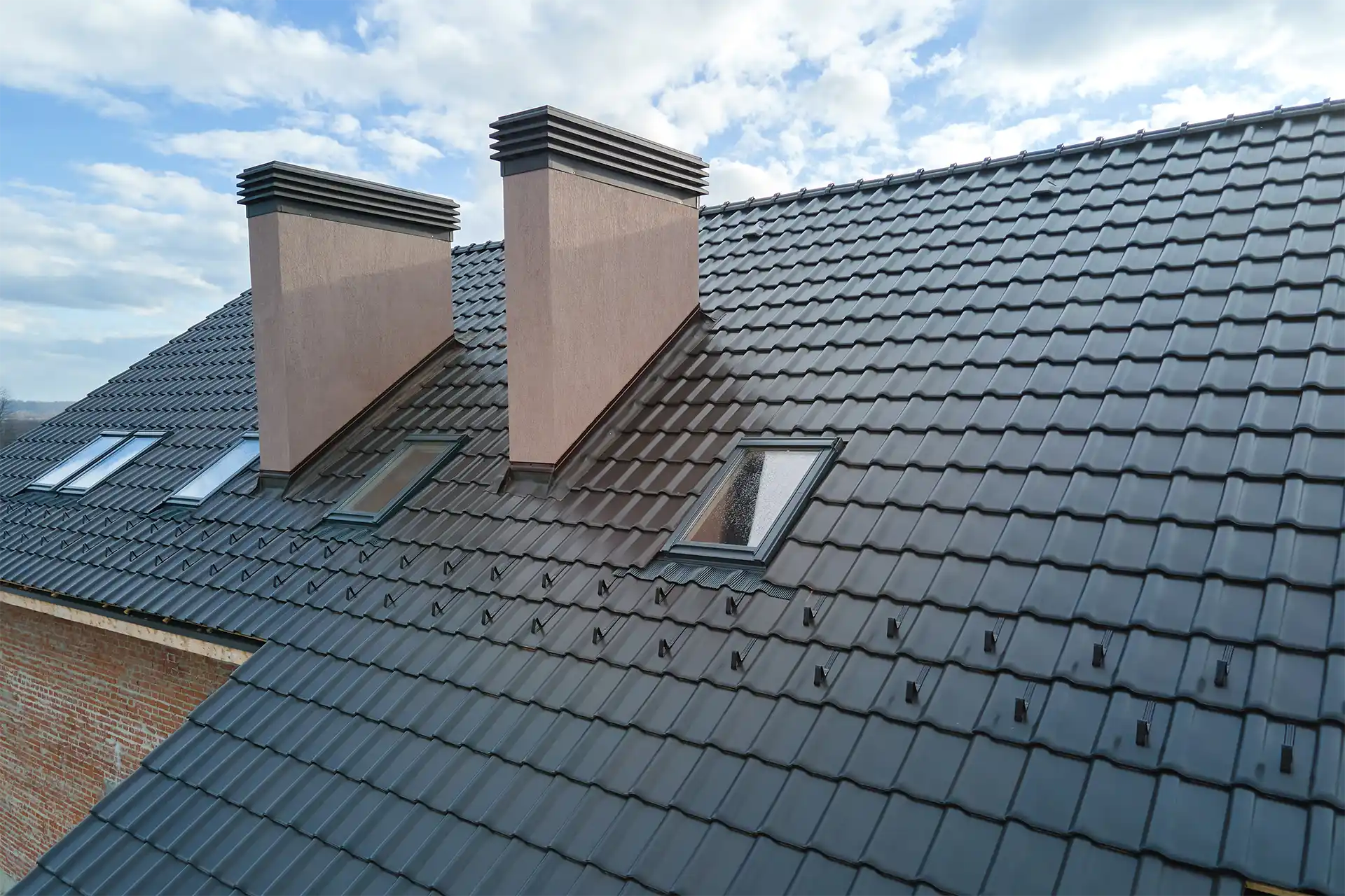 Aerial view of a home with a gray asphalt shingle roof