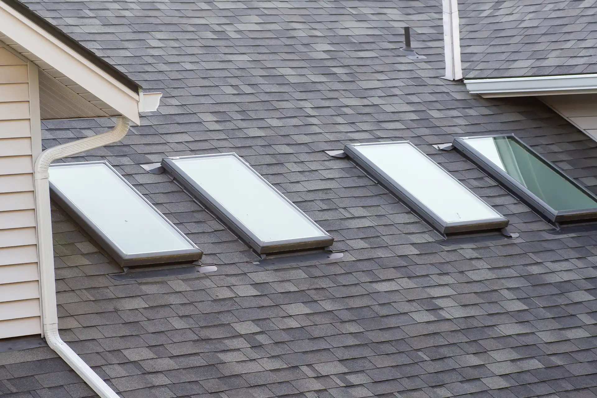 Aerial view of a home with a gray asphalt shingle roof